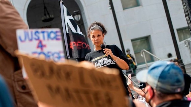 Melina Abdullah from Black Lives Matter addresses the crowd during a demonstration to ask for the removal of District Attorney Jackie Lacey in front of the Hall of Justice, in Los Angeles, California, on June 17, 2020. (Photo by VALERIE MACON / AFP) (Photo by VALERIE MACON/AFP via Getty Images)