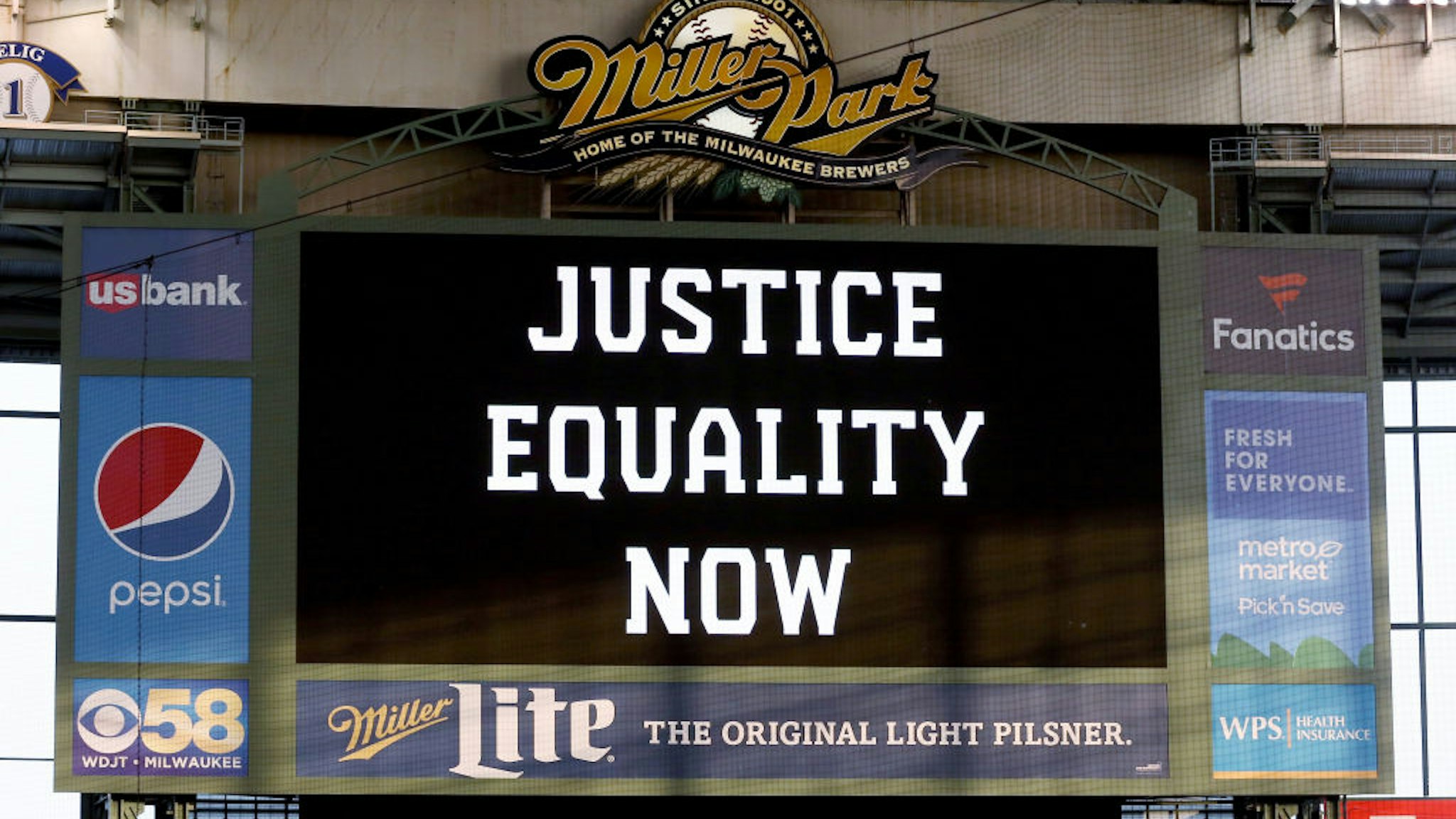 MILWAUKEE, WISCONSIN - AUGUST 25: The scoreboard displays a message of "Justice Equality Now" before the game between the Cincinnati Reds and Milwaukee Brewers at Miller Park on August 25, 2020 in Milwaukee, Wisconsin.