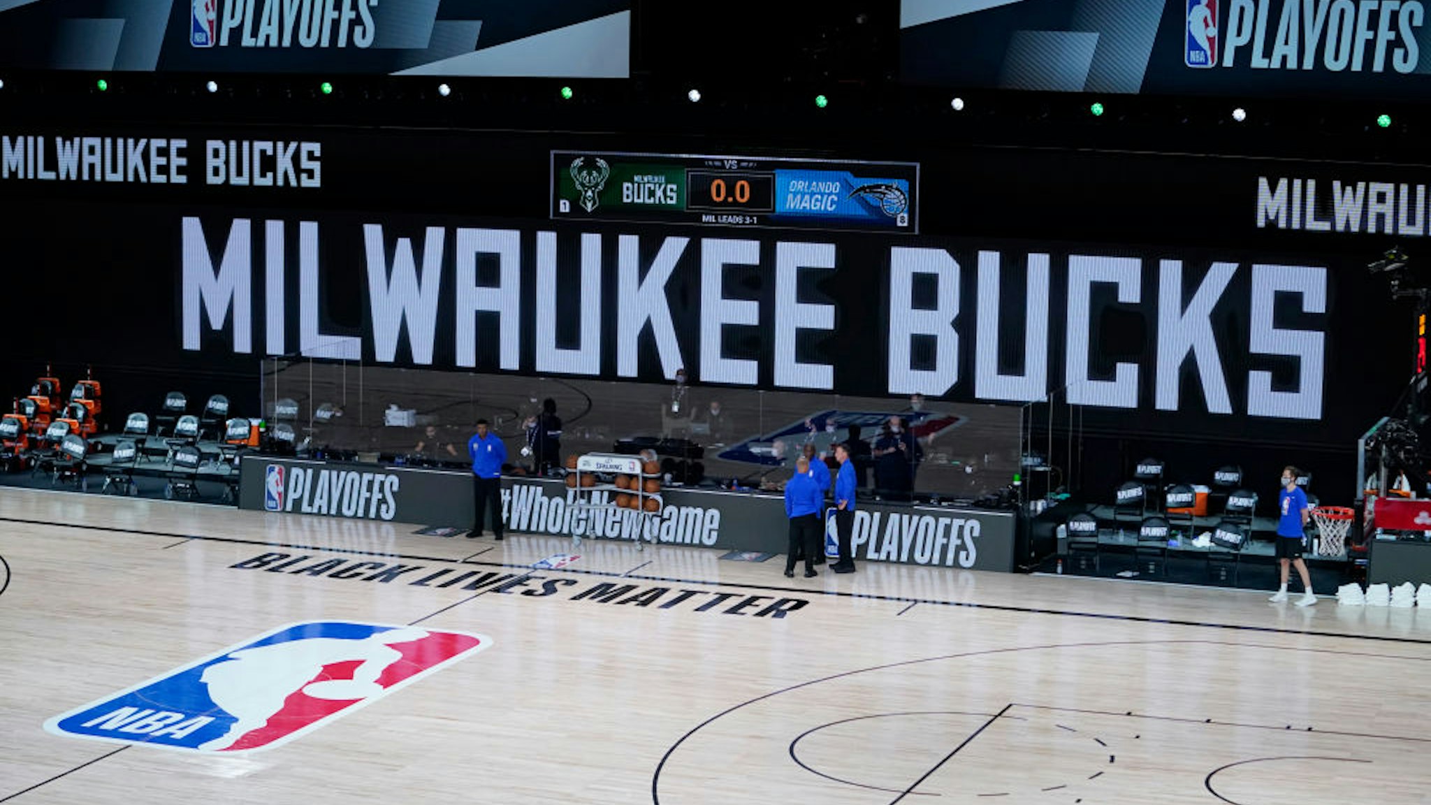 LAKE BUENA VISTA, FLORIDA - AUGUST 26: Officials stand beside an empty court after the scheduled start of game five between the Milwaukee Bucks and the Orlando Magic in the first round of the 2020 NBA Playoffs at AdventHealth Arena at ESPN Wide World Of Sports Complex on August 26, 2020 in Lake Buena Vista, Florida. According to reports, the Milwaukee Bucks have boycotted their game 5 playoff game against the Orlando Magic to protest the shooting of Jacob Blake by Kenosha, Wisconsin police. NOTE TO USER: User expressly acknowledges and agrees that, by downloading and or using this photograph, User is consenting to the terms and conditions of the Getty Images License Agreement.