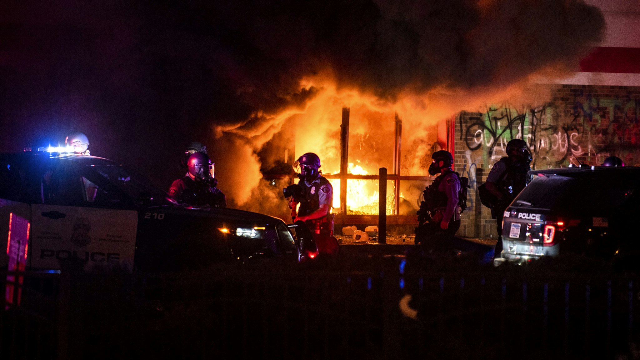 MINNEAPOLIS, MN - MAY 27: A fire burns inside of an Auto Zone store near the Third Police Precinct on May 27, 2020 in Minneapolis, Minnesota. Businesses near the Third Police Precinct were looted and damaged today as the area has become the site of an ongoing protest after the police killing of George Floyd. Four Minneapolis police officers have been fired after a video taken by a bystander was posted on social media showing Floyd's neck being pinned to the ground by an officer as he repeatedly said, "I can’t breathe". Floyd was later pronounced dead while in police custody after being transported to Hennepin County Medical Center.