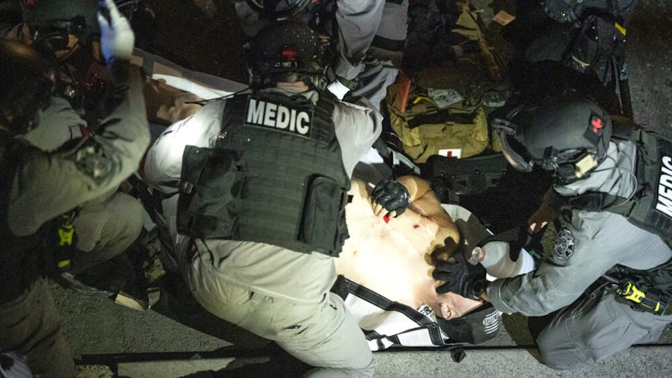 Police arrive to treat a man who was shot near a Pro-Trump rally on August 29, 2020 in Portland, Oregon. Far left counter-protesters and pro-trump supporters clashed Saturday afternoon as a parade of cars carrying right wing supporters made their way from nearby Clackamas to Portland.