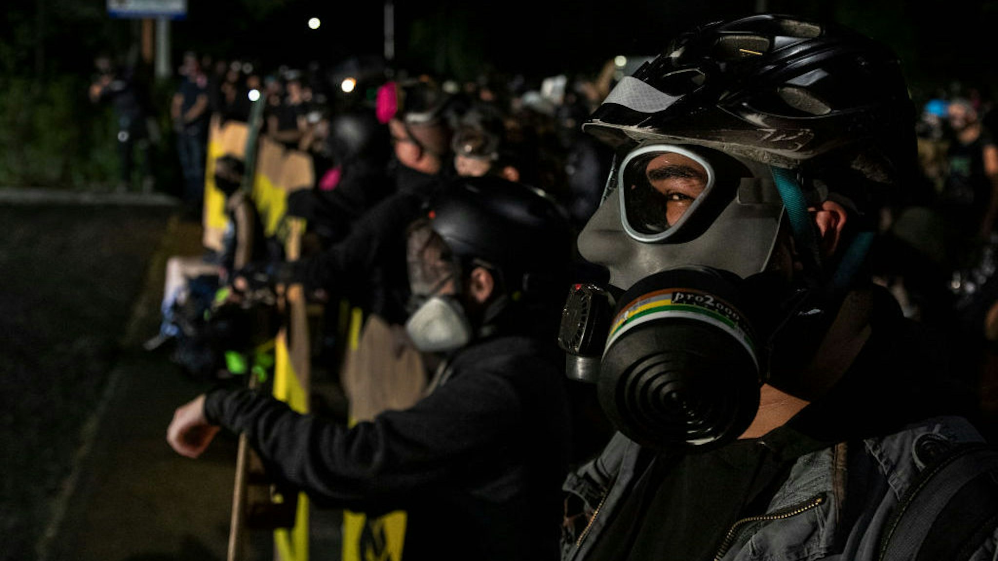 Protesters are seen during a standoff at a Portland police precinct in Portland, Oregon on August 15, 2020. Protests have continued for the 80th consecutive night in Portland since the killing of George Floyd. (Photo by Paula Bronstein/Getty Images )