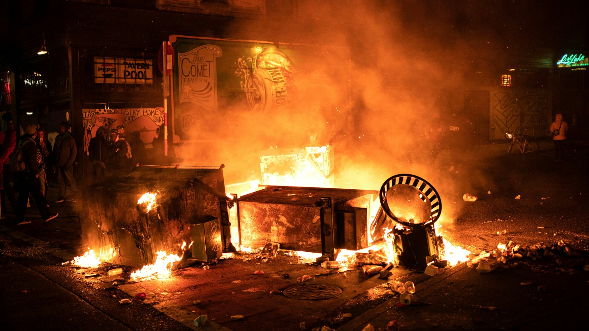 SEATTLE, WA - JUNE 08: A fire burns in the street after demonstrators clashed with law enforcement near the Seattle Police Departments East Precinct shortly after midnight on June 8, 2020 in Seattle, Washington. Earlier in the evening, a suspect drove into the crowd of protesters and shot one person, which happened after a day of peaceful protests across the city. Later, police and protesters clashed violently during ongoing Black Lives Matter demonstrations following the death of George Floyd.