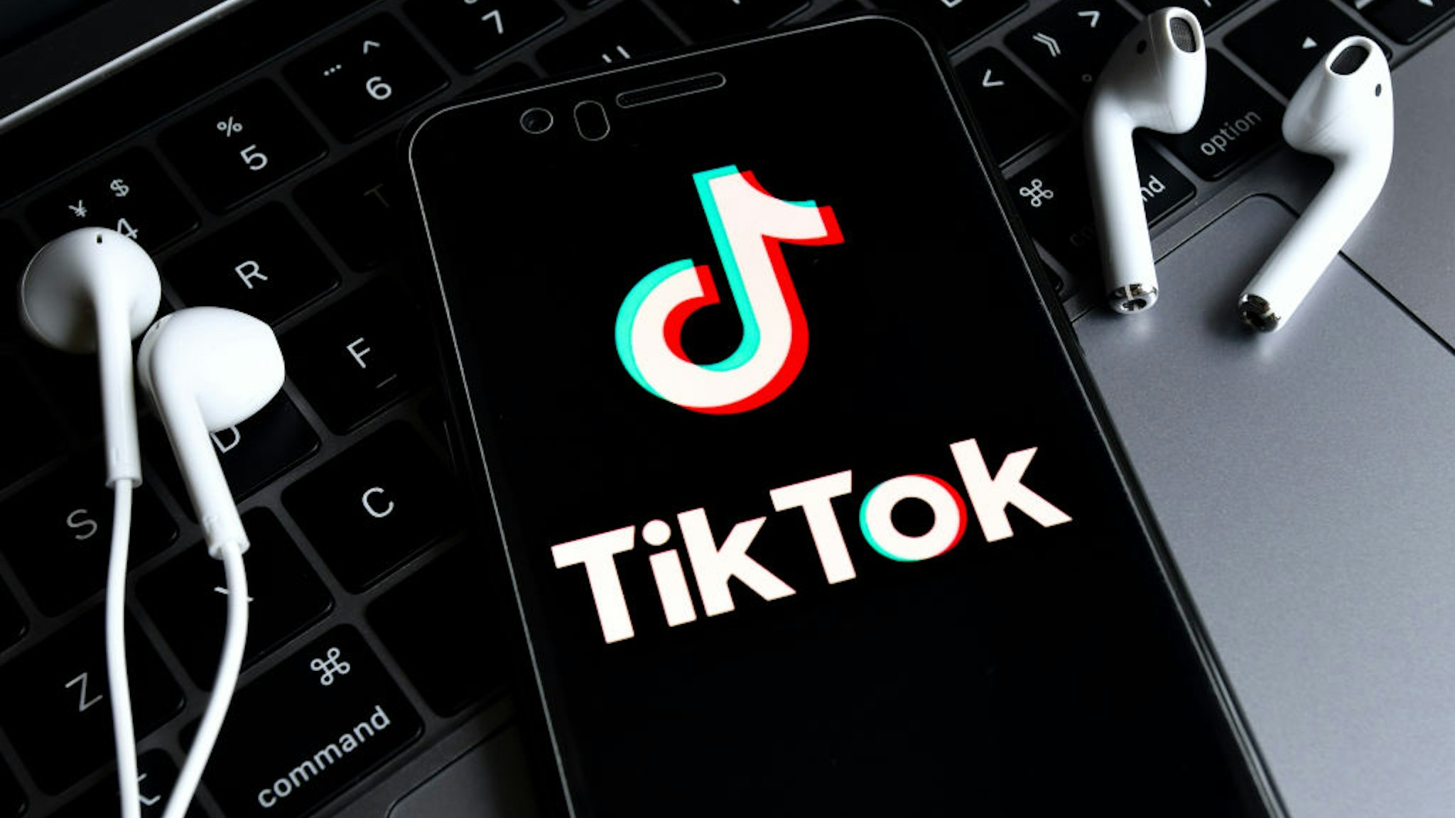 HAIKOU, HAINAN, CHINA - 2020/08/23: In this photo illustration, a TikTok logo seen displayed on a smartphone with a computer in the background. ByteDance, parent company of popular video-sharing app TikTok on Sunday confirmed it would be filing a lawsuit on Monday local time against the Trump administration over the executive order signed by President Donald Trump banning its service in the United States.