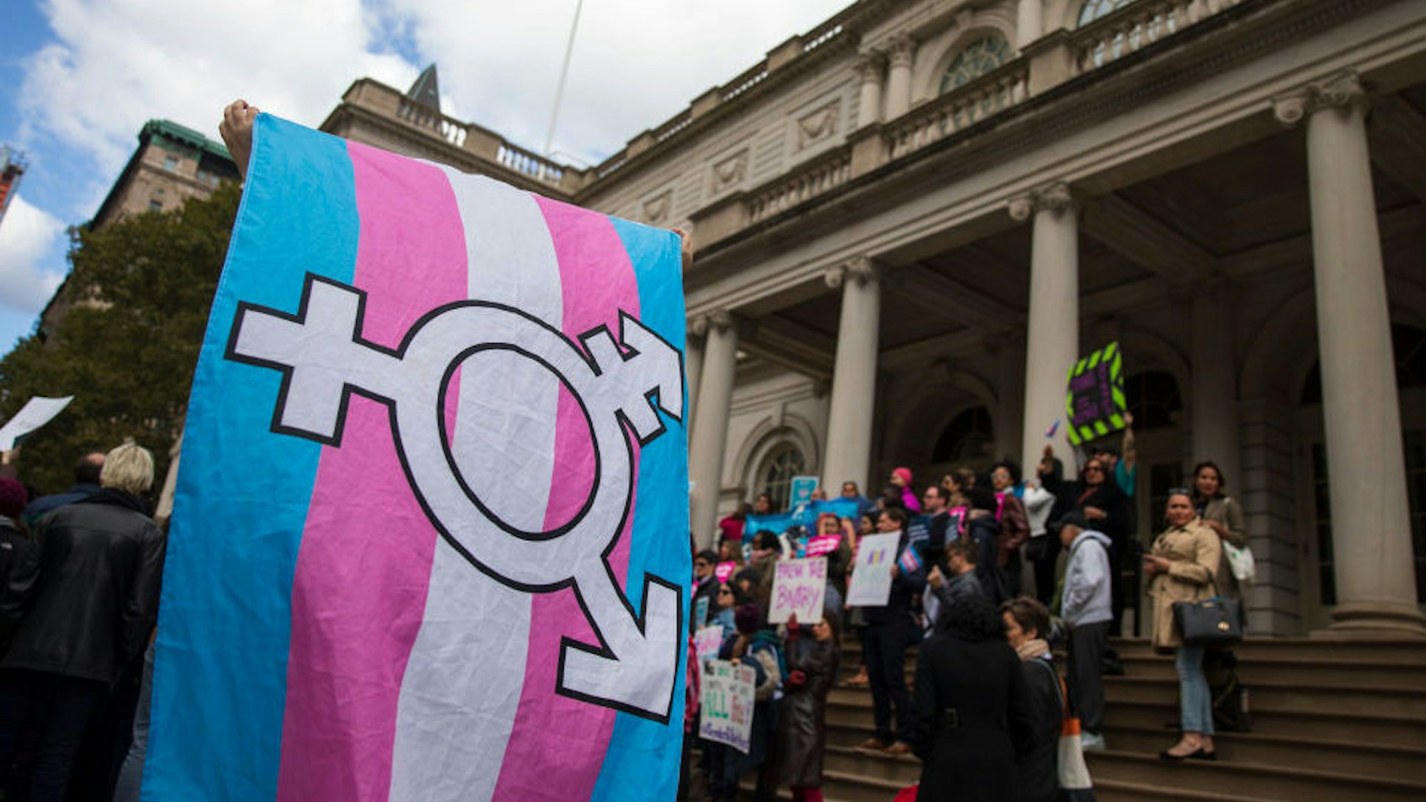 L.G.B.T. activists and their supporters rally in support of transgender people on the steps of New York City Hall, October 24, 2018 in New York City. The group gathered to speak out against the Trump administration's stance toward transgender people. Last week, The New York Times reported on an unreleased administration memo that proposes a strict biological definition of gender based on a person's genitalia at birth. (Photo by Drew Angerer/Getty Images)