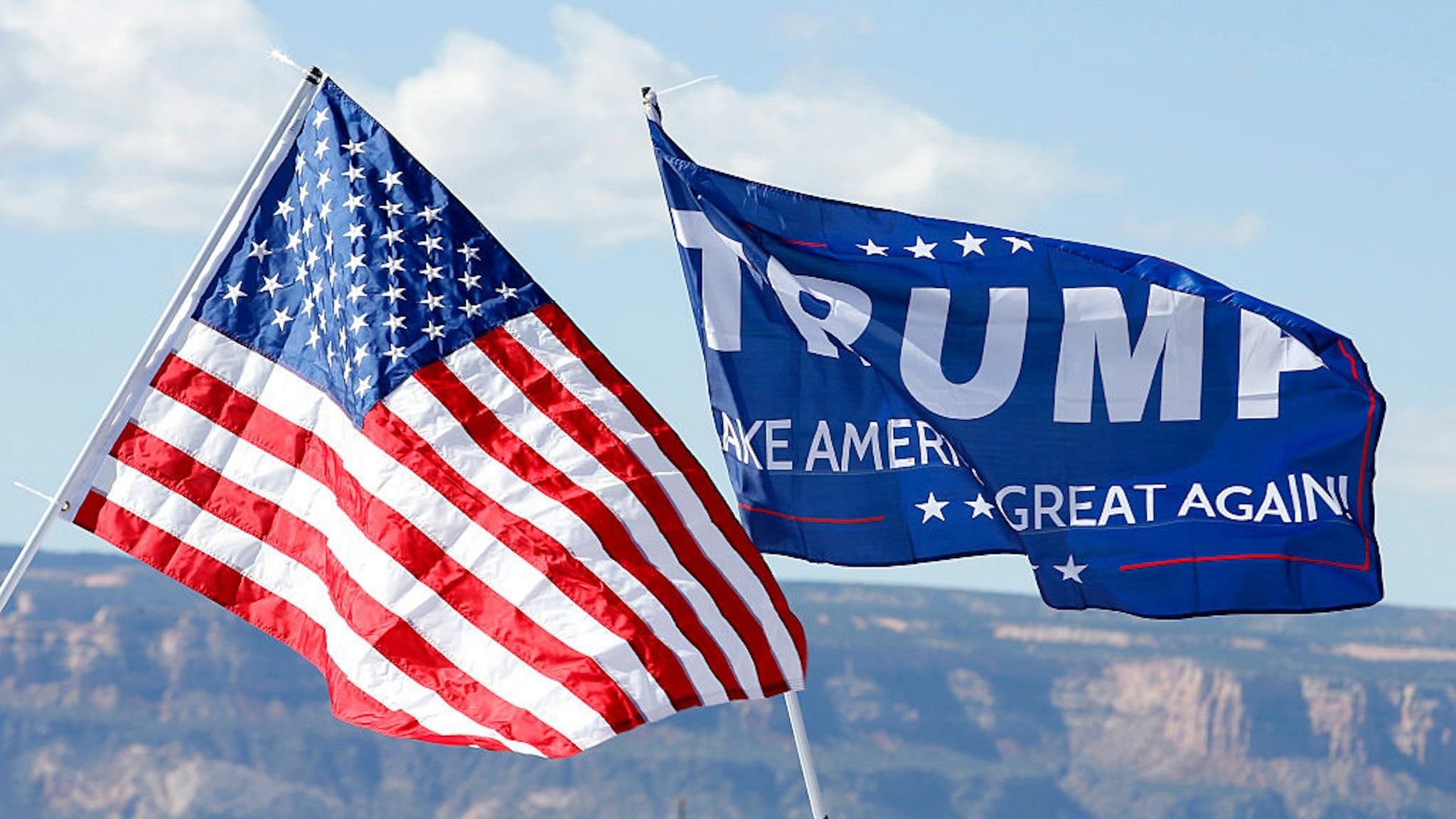 GRAND JUNCTION, CO - OCTOBER 18: With the Colorado National Monument in the background, an American flag and a Trump flag flies at a rally where Republican Presidential Candidate Donald Trump will speak on October 18, 2016 in Grand Junction, Colorado. Trump is on his way to Las Vegas for the third and final presidential debate against Democratic presidential candidate Hillary Clinton. (Photo by George Frey/Getty Images