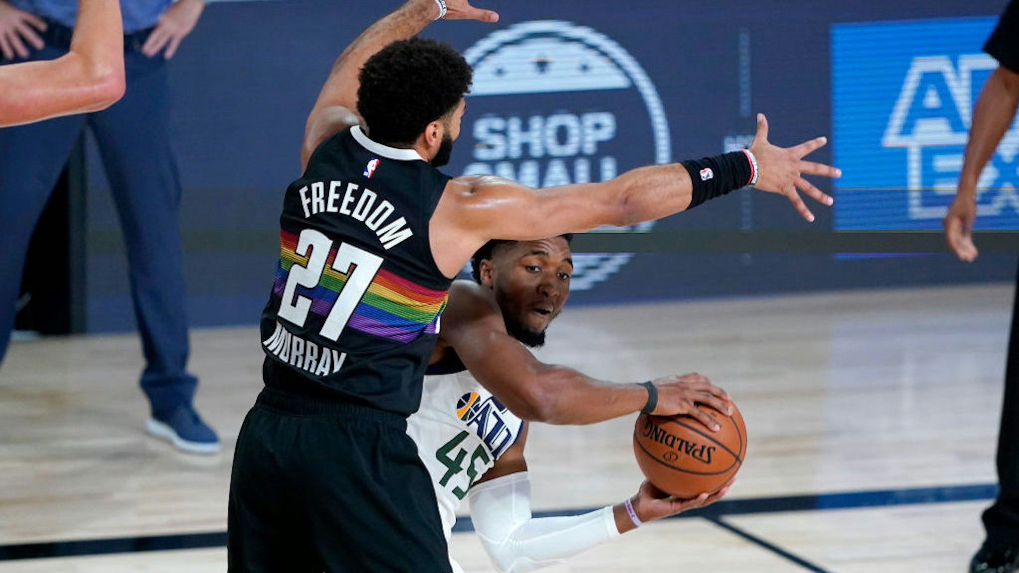 Utah Jazz's Donovan Mitchell (45) is pressured by Denver Nuggets' Jamal Murray (27) during the first half of an NBA basketball first round playoff game, Monday, Aug. 3, 2020, in Lake Buena Vista, Fla.(AP Photo/Ashley Landis, Pool)