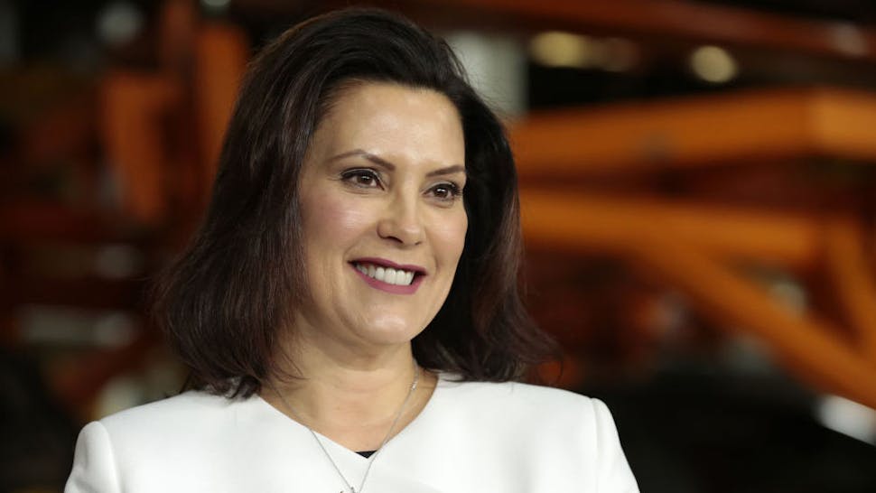 Gretchen Whitmer, governor of Michigan, smiles during an event at the General Motors Co. Orion Assembly plant in Orion Township, Michigan, U.S., on Friday, March 22, 2019. General Motors Co. committed to investing $1.8 billion at plants in six states and to creating 700 new jobs, as the largest U.S. automaker looks to ward off months of criticism by President Donald Trump.