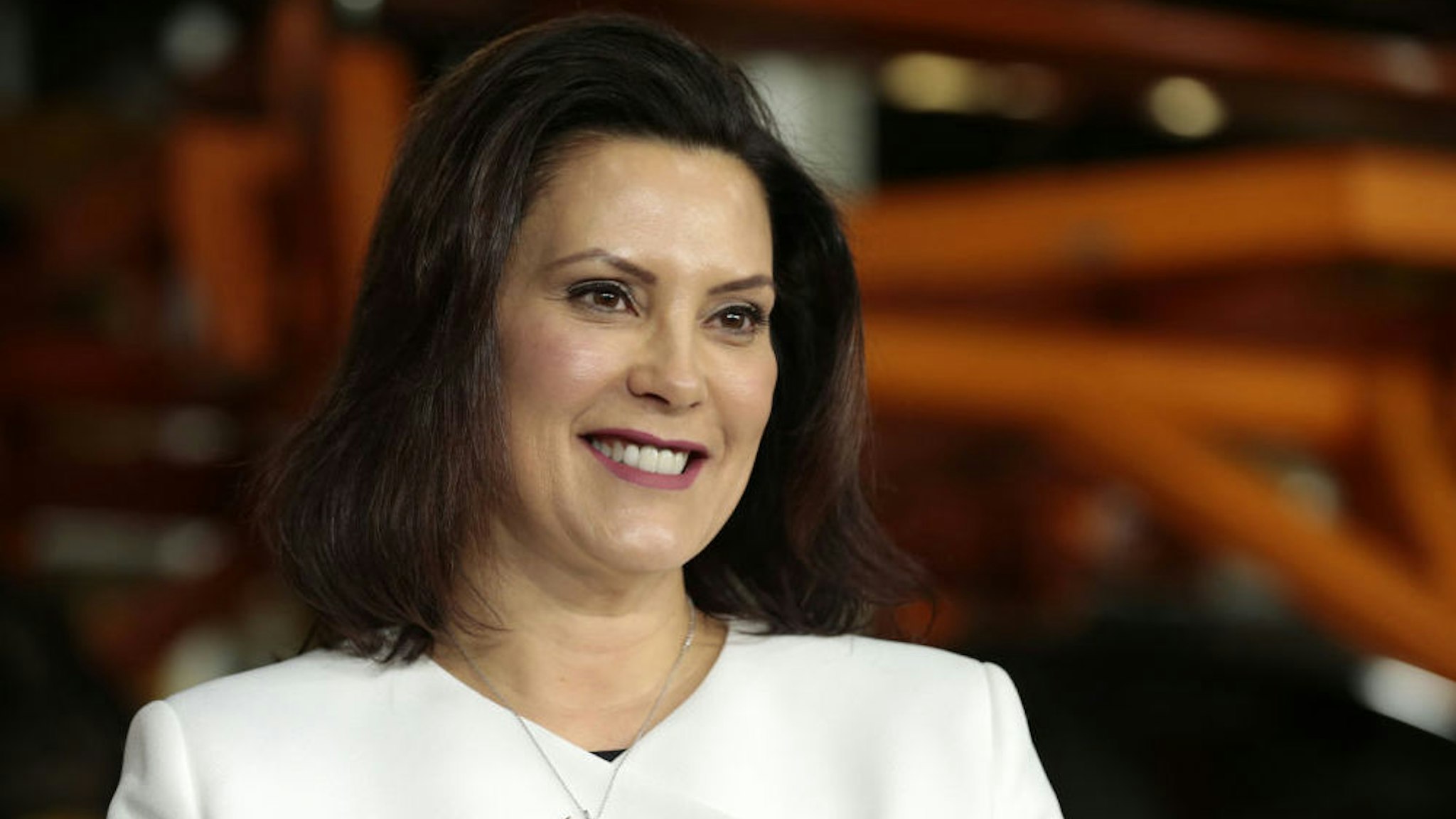 Gretchen Whitmer, governor of Michigan, smiles during an event at the General Motors Co. Orion Assembly plant in Orion Township, Michigan, U.S., on Friday, March 22, 2019. General Motors Co. committed to investing $1.8 billion at plants in six states and to creating 700 new jobs, as the largest U.S. automaker looks to ward off months of criticism by President Donald Trump.