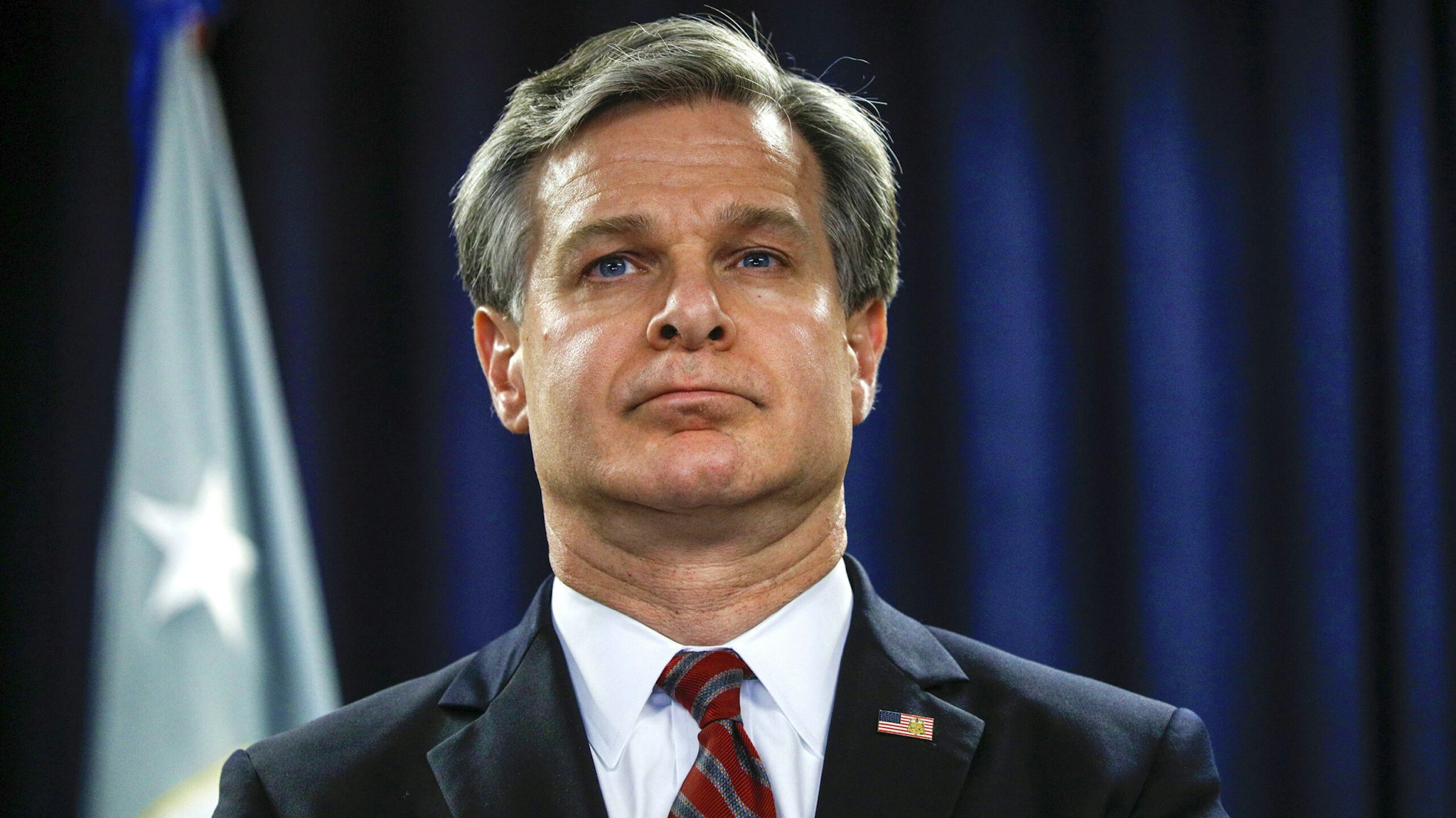 FBI Director Christopher Wray waits to speak at the announcement of a new Crime Reduction Initiative designed to reduce crime in Detroit on December 18, 2019 in Detroit, Michigan.