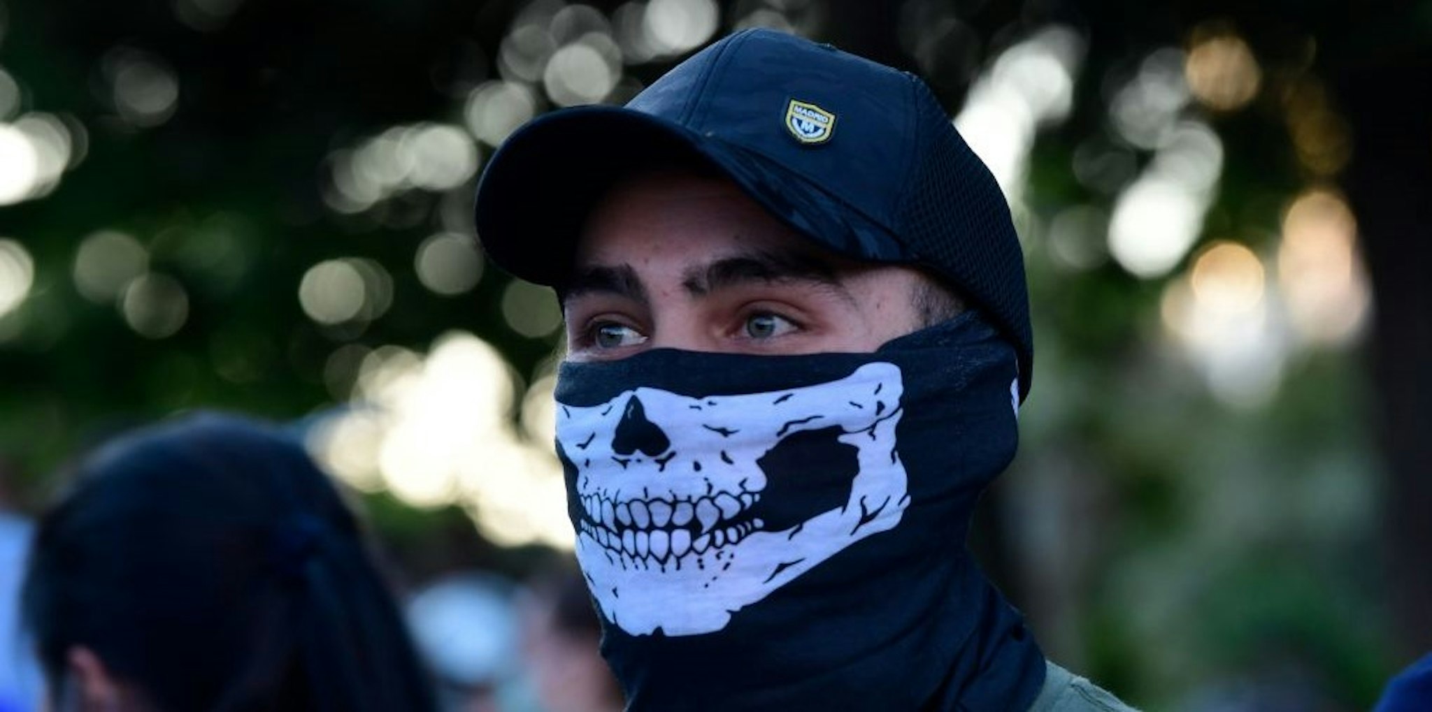 A demonstrator covers his face with a neck gaiter as he takes part in a demonstration against the government's handling of the coronavirus crisis, on May 20, 2020, in Alcorcon, near Madrid. - Spain's prime minister won parliamentary backing extend the lockdown for another two weeks today, despite opposition from his rightwing opponents and protests against his minority coalition government. It was the fifth time the state of emergency has been renewed, meaning the restrictions will remain in force until June 6 in a measure passed by 177 votes in favour, 162 against and 11 abstentions. (Photo by JAVIER SORIANO / AFP) (Photo by