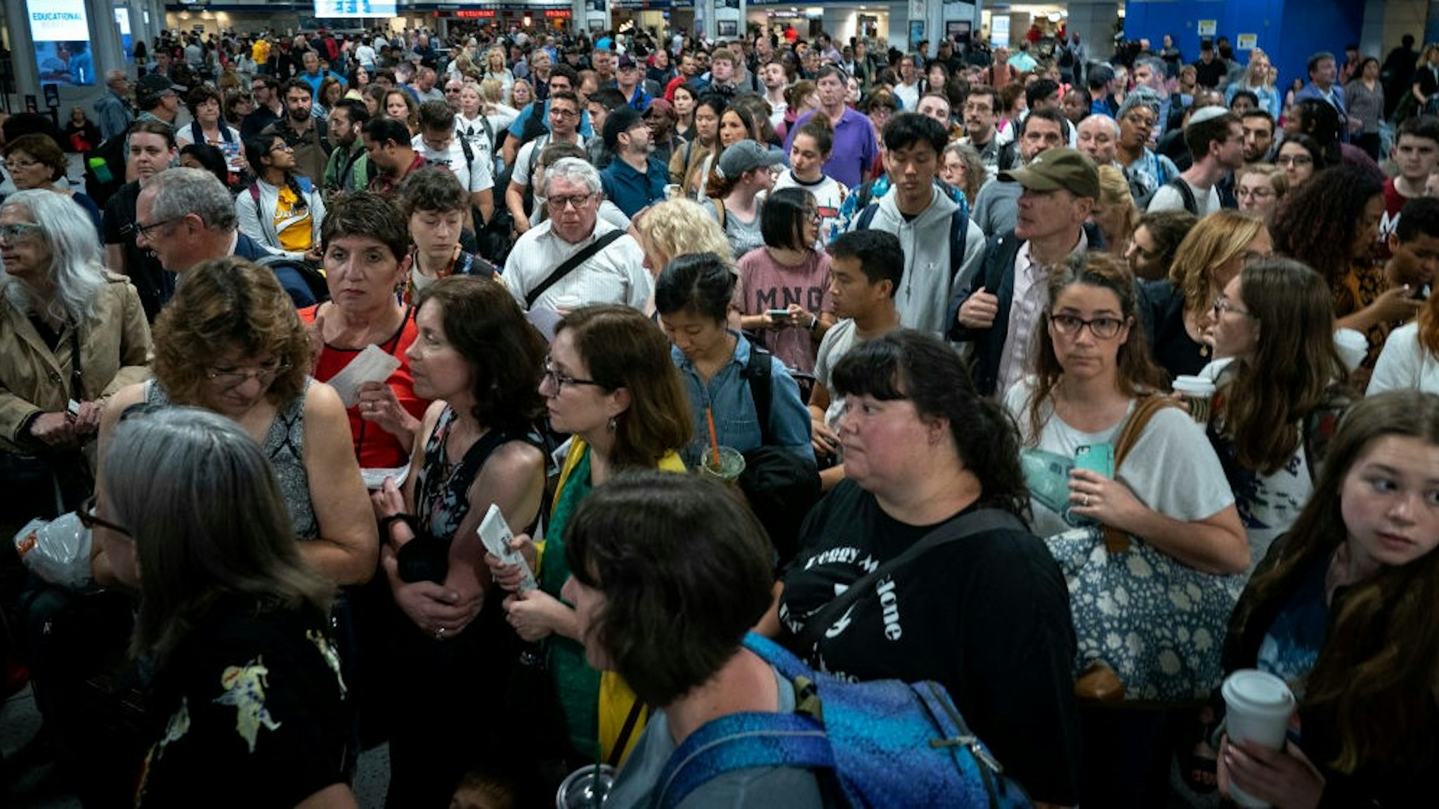 NEW YORK, NY - JUNE 19: Passengers line up to board a delayed Amtrak train at New York Penn Station, June 19, 2019 in New York City. Power outage issues on Amtrak and New Jersey Transit train lines halted all trains in and out of New York Penn Station on Wednesday morning. (Photo by