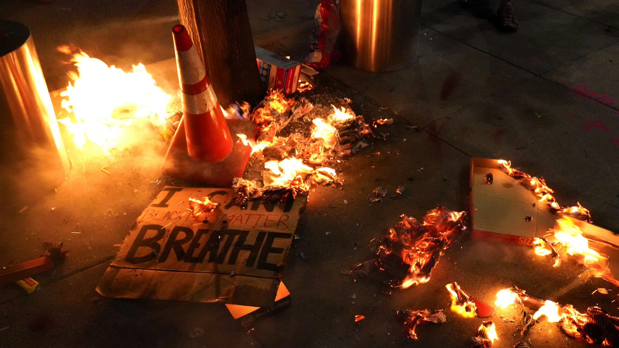 PORTLAND, OR - JULY 20: A fire burns around a sign reading I cant breathe during a protest in front of the Mark O. Hatfield U.S. Courthouse on July 201, 2020 in Portland, Oregon. Monday night marked 54 days of protests in Portland following the death of George Floyd in police custody.