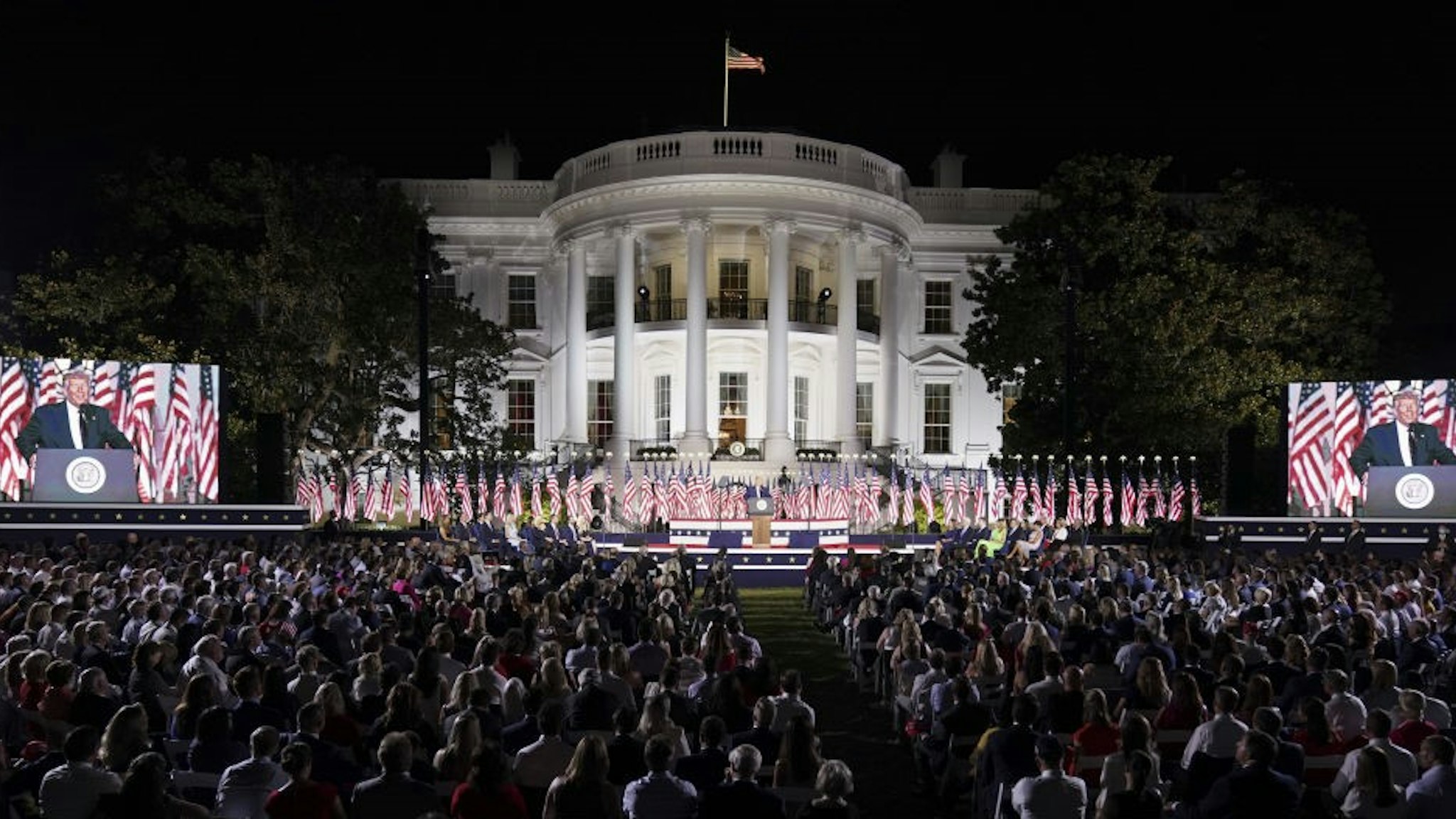 U.S. President Donald Trump, center, speaks during the Republican National Convention on the South Lawn of the White House in Washington, D.C., U.S., on Thursday, Aug. 27, 2020. Trump is asking Americans to return him to office in the speech closing the convention, arguing that voters can't trust Joe Biden or the Democratic Party to navigate the coronavirus pandemic or salve the nation's racial divisions. Photographer: