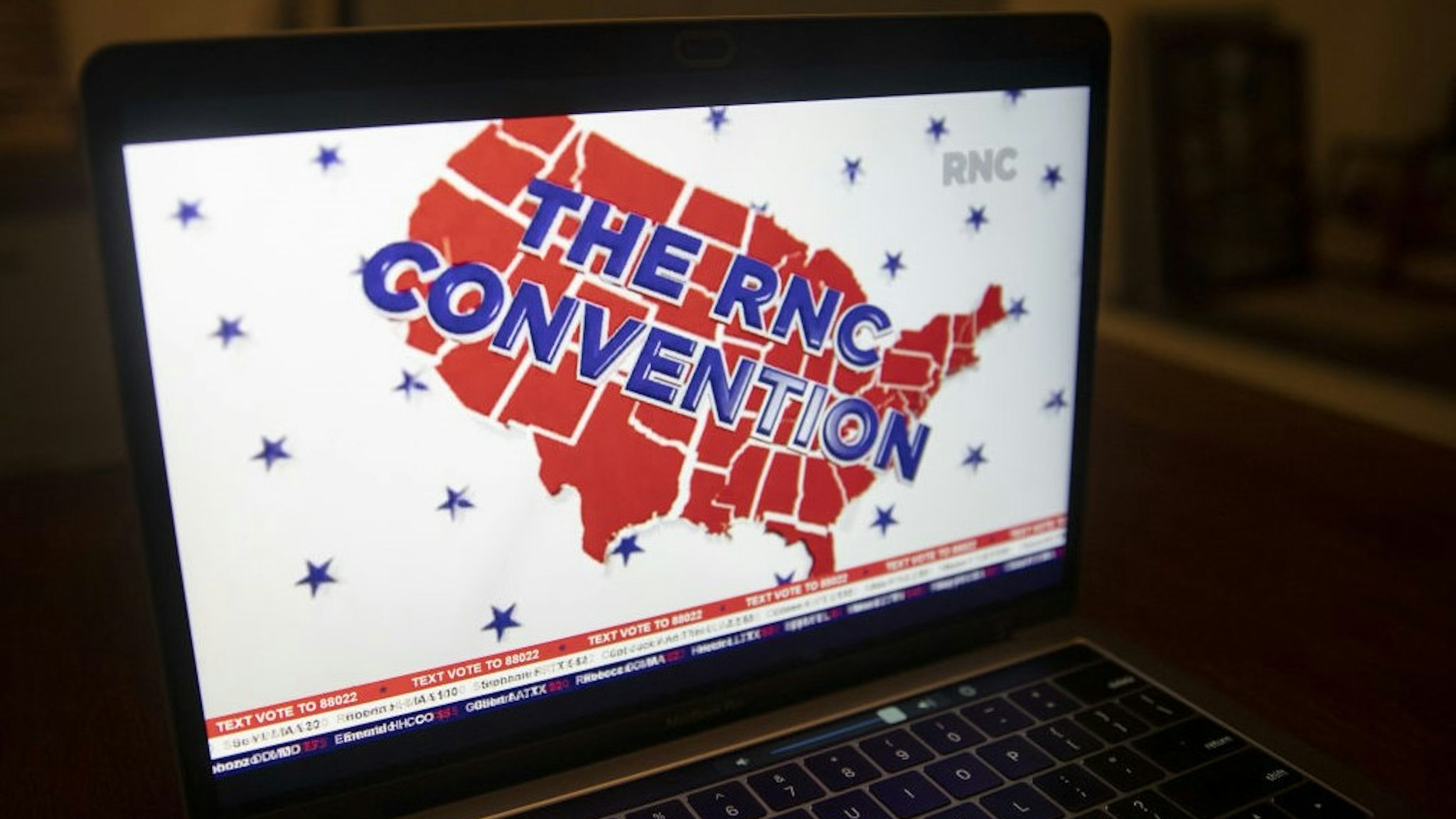 A logo is displayed at the start of the Republican National Convention seen on a laptop computer in Tiskilwa, Illinois, U.S., on Monday, Aug. 24, 2020. President Trump plans to appear nightly during the four-day convention, which after today will be staged mostly from Washington because of the coronavirus pandemic. Photographer: