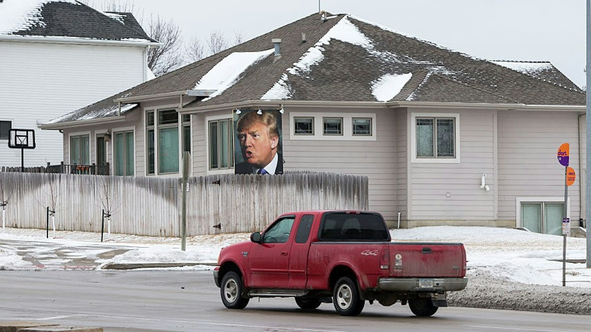 UNITED STATES - JANUARY 26 - A truck drives past a giant poster of Republican presidential candidate Donald Trump in supporter George Davey's backyard in West Des Moines, Iowa, Tuesday, January 26, 2016. (Photo By