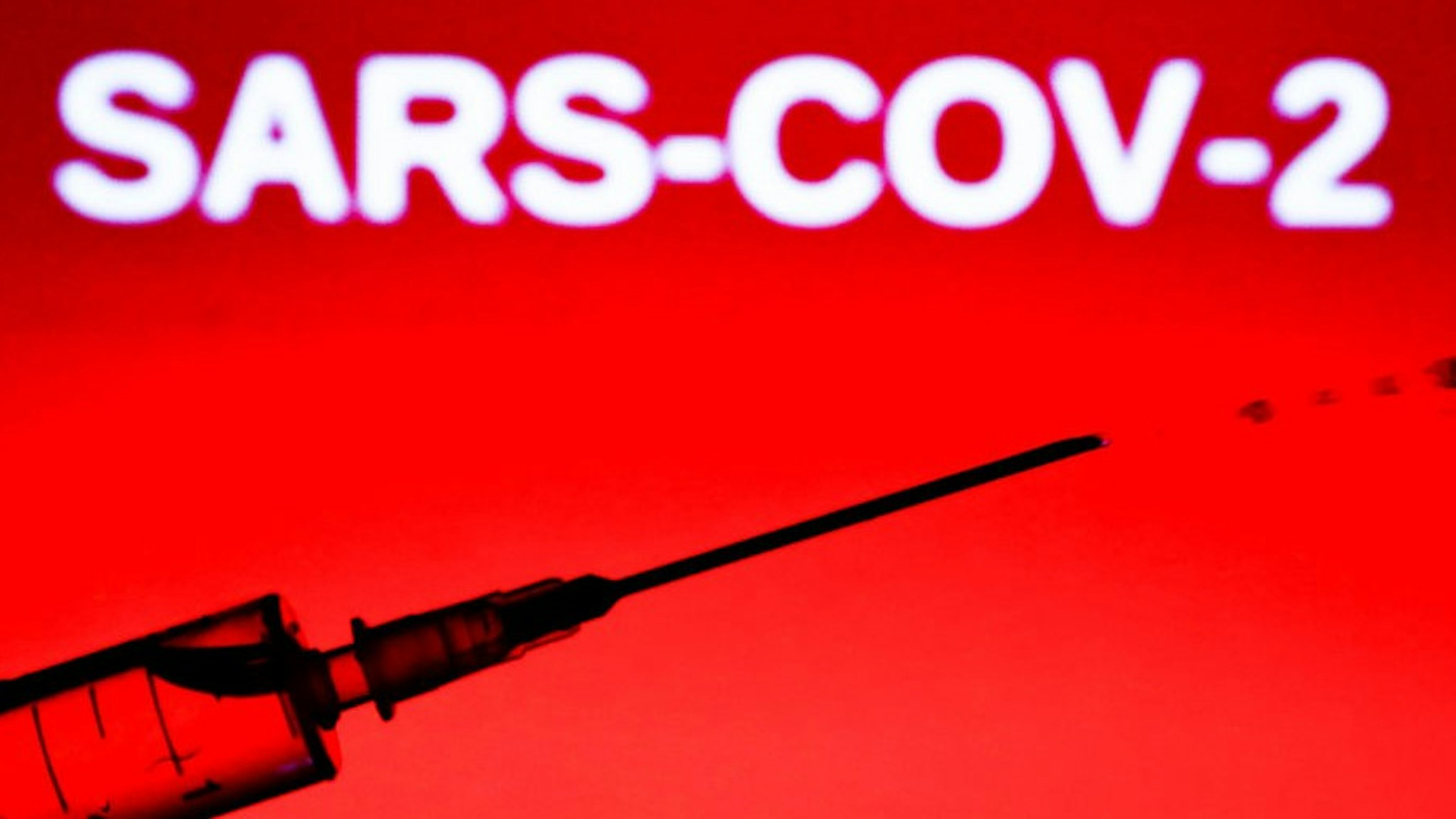 In this illustration photo a medical syringe is seen with 'sars-cov-2' sign in the background. Picture taken in Krakow, Poland, on June 9, 2020. (Photo by