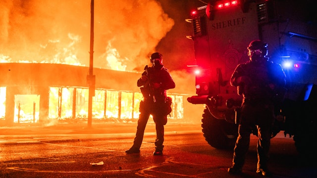 KENOSHA, WI - AUGUST 24: A police armored vehicle patrols an intersection on August 24, 2020 in Kenosha, Wisconsin. This is the second night of rioting after the shooting of Jacob Blake, 29, on August 23. Blake was shot multiple times in the back by Wisconsin police officers after attempting to enter into the drivers side of a vehicle.