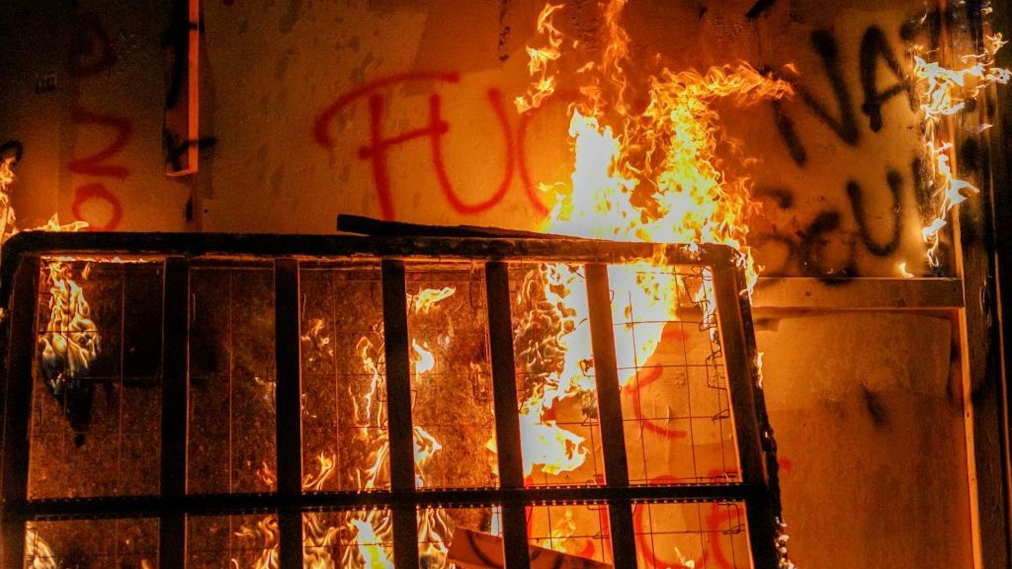 About two hundred persons protesting police brutality spray graffiti and start fires at the Portland Police Union building, in Portland, Oregon, United States on August 28, 2020, the 93rd day of consecutive protests. Police declared a riot and arrested many people. (Photo by John Rudoff/Anadolu Agency via Getty Images)