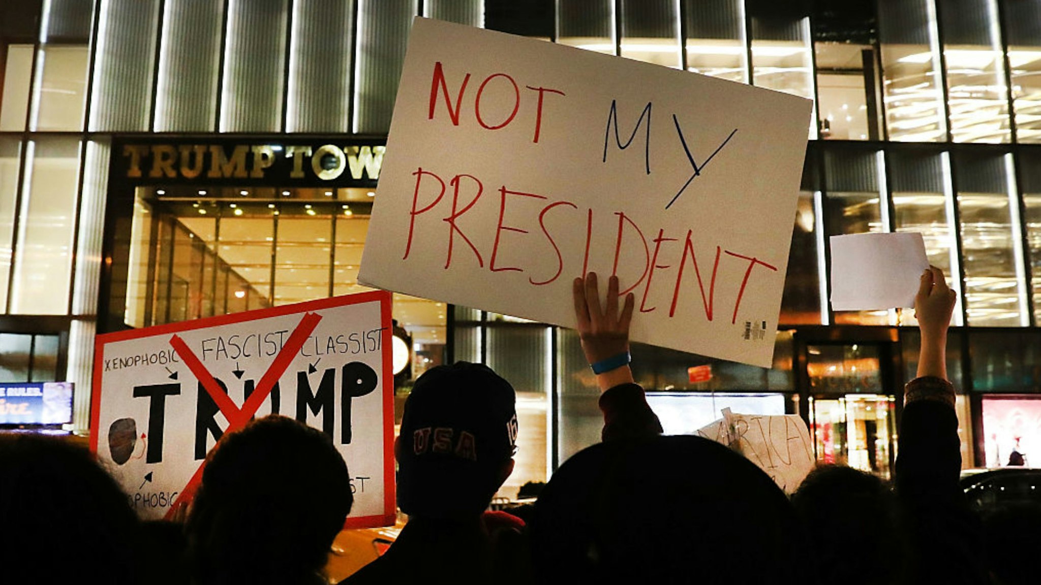 Dozens of anti-Donald Trump protesters stand along 5th Avenue in front of Trump Tower as New Yorkers react for a second night to the election of Trump as president of the United States on November 10, 2016 in New York City.