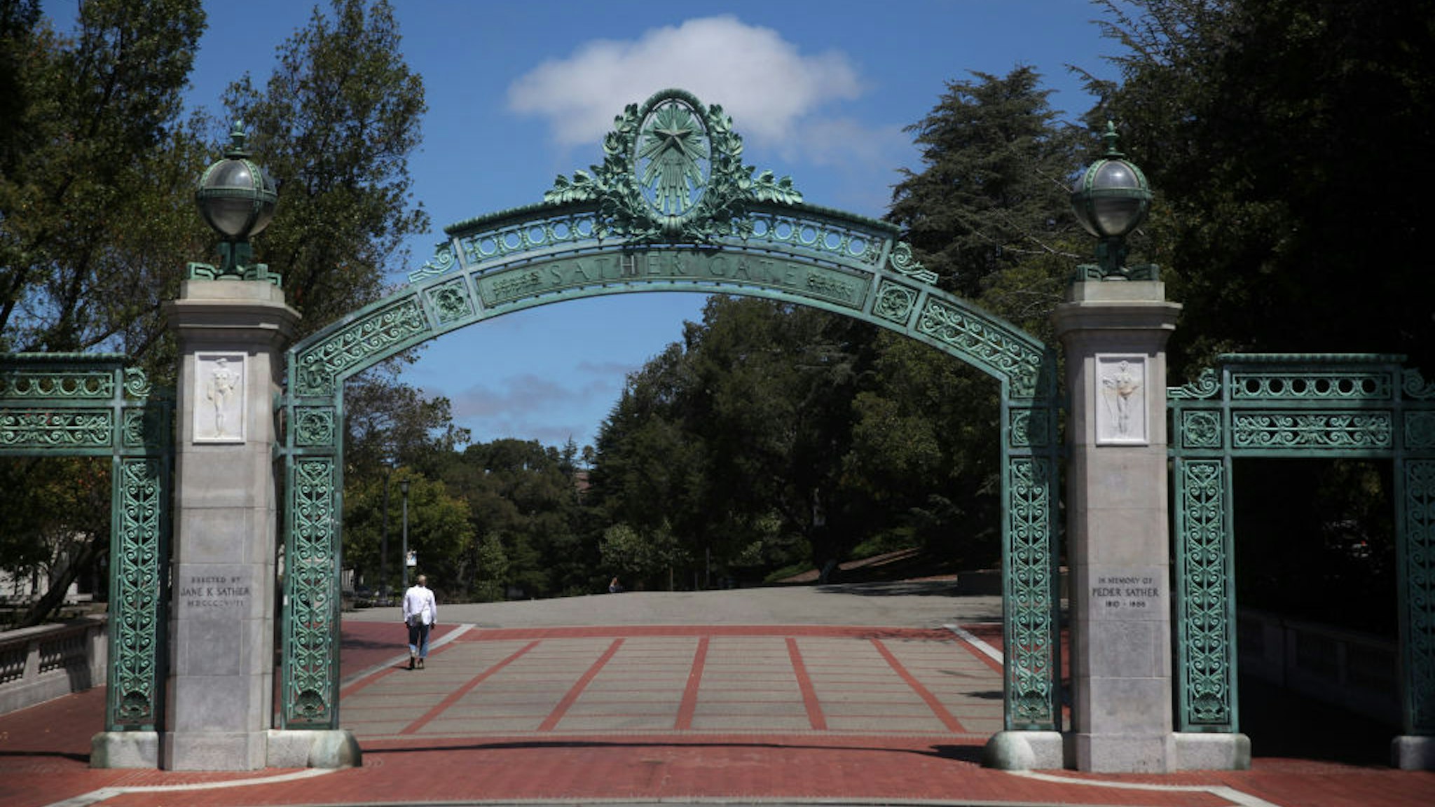 BERKELEY, CALIFORNIA - JULY 22: A lone pedestrian walks by Sather Gate on the U.C. Berkeley campus on July 22, 2020 in Berkeley, California. U.C. Berkeley announced plans on Tuesday to move to online education for the start of the school's fall semester due to the coronavirus COVID-19 pandemic.