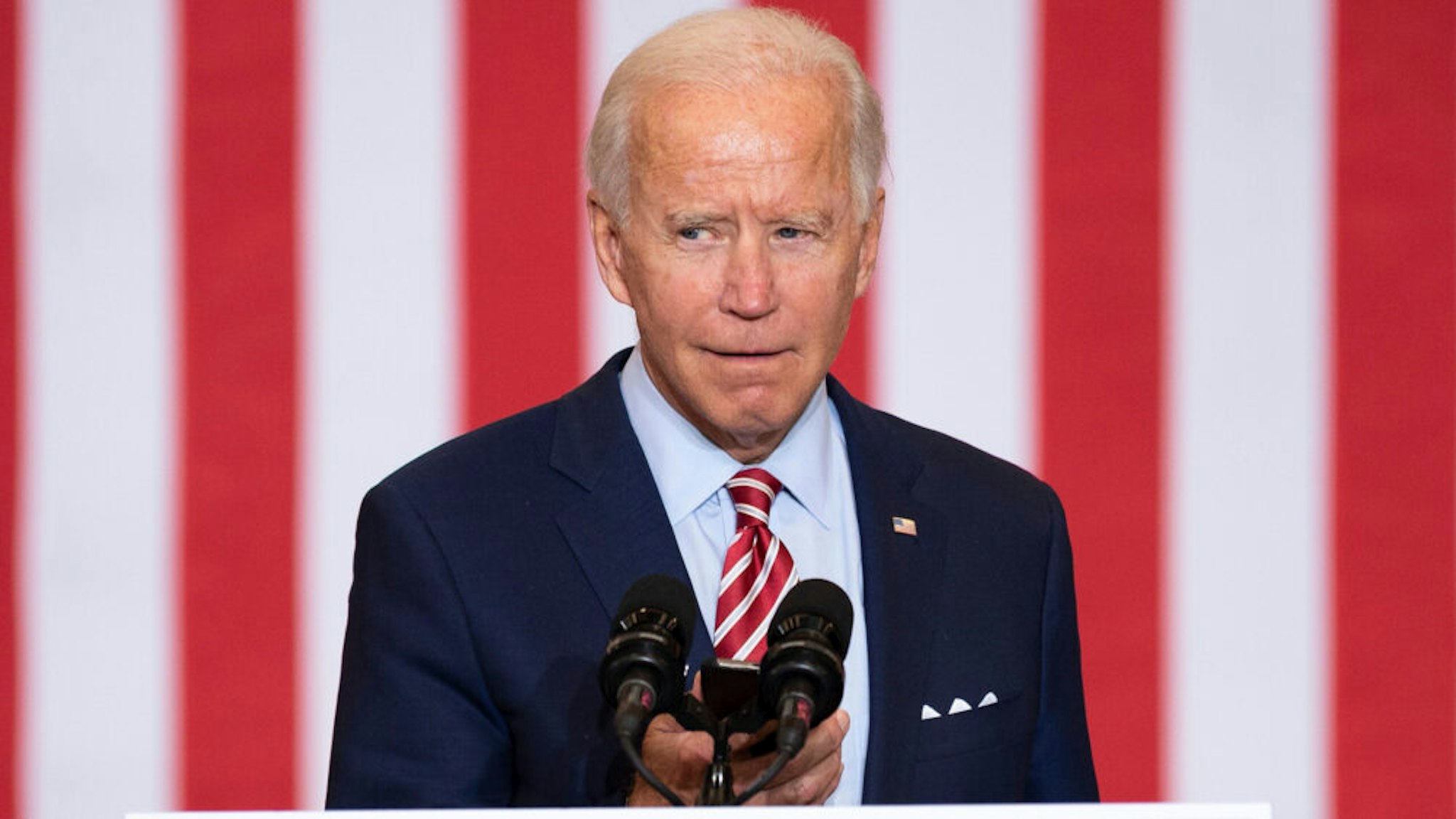 Democratic Presidential Candidate Joe Biden plays music from his cell phone as he participates in a Hispanic Heritage Month event at the Osceola Heritage Park in Kissimmee, Florida on September 15, 2020.