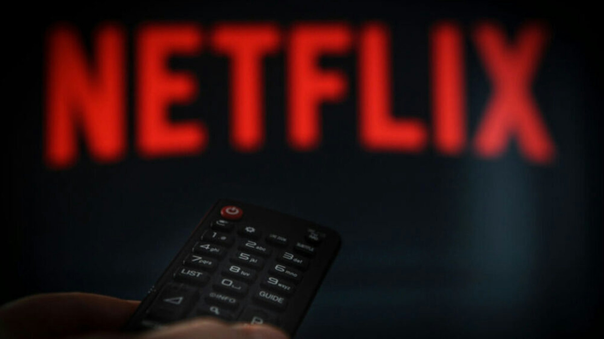 A remote control is seen being held in front of a television running the Netflix application on October 25, 2017.
