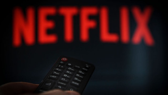 A remote control is seen being held in front of a television running the Netflix application on October 25, 2017.
