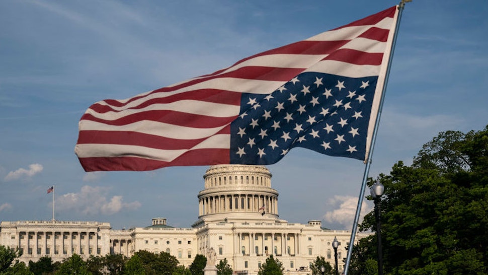 U.S. Capitol with upside U.S. flag
