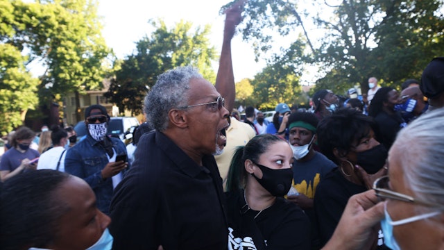 ROCHESTER, NEW YORK - SEPTEMBER 03: Asa Adams yells at an unknown person after a disagreement about a vigil for Daniel Prude on September 03, 2020 in Rochester, New York. Prude died after being arrested on March 23 by Rochester police officers who had placed a "spit hood" over his head and pinned him to the ground while restraining him. Mayor Lovely Warren announced today the suspension of seven officers involved in the arrest. (Photo by Michael M. Santiago/Getty Images)