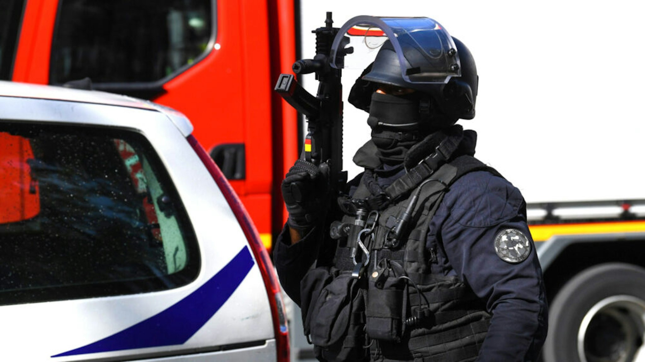 A French police intervention unit (GSO) officer secures the area after several people were injured near the former offices of the French satirical magazine Charlie Hebdo following an attack by a man wielding a knife in the capital Paris on September 25, 2020. - Four people were injured, two seriously, in a knife attack in Paris on September 25, 2020, near the former offices of French satirical magazine Charlie Hebdo, a source close to the investigation told AFP. Two of the victims were in a critical condition, the Paris police department said, adding two suspects were on the run. The stabbing came as a trial was underway in the capital for alleged accomplices of the authors of the January 2015 attack on the Charlie Hebdo weekly that claimed 12 lives.