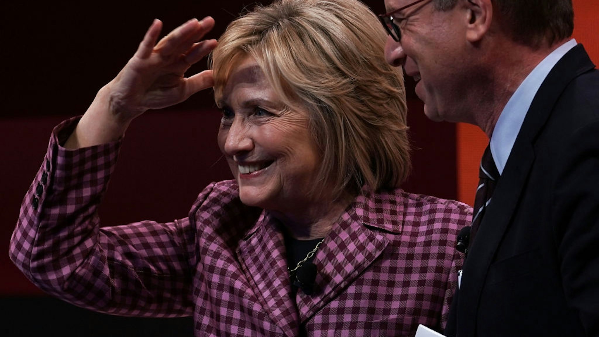 Former U.S. Secretary of State Hillary Clinton waves to audiences as Atlantic editor in chief Jeffrey Goldberg looks on after a discussion during the 2018 Atlantic Festival October 2, 2018 in Washington, DC.