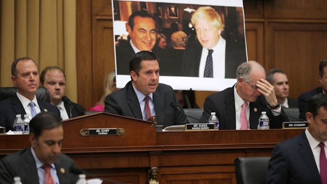 With a photograph of British Prime Minister Boris Johnson (L) and Joseph Mifsud in the background, ranking member Rep. Devin Nunes (R-CA) (C) questions former Special Counsel Robert Mueller as Mueller appears before the House Intelligence Committee about his report on Russian interference in the 2016 presidential election in the Rayburn Hose Office Building July 24, 2019 in Washington, DC.