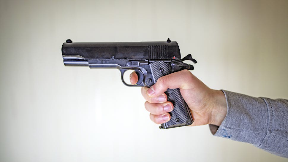 while man holding gun