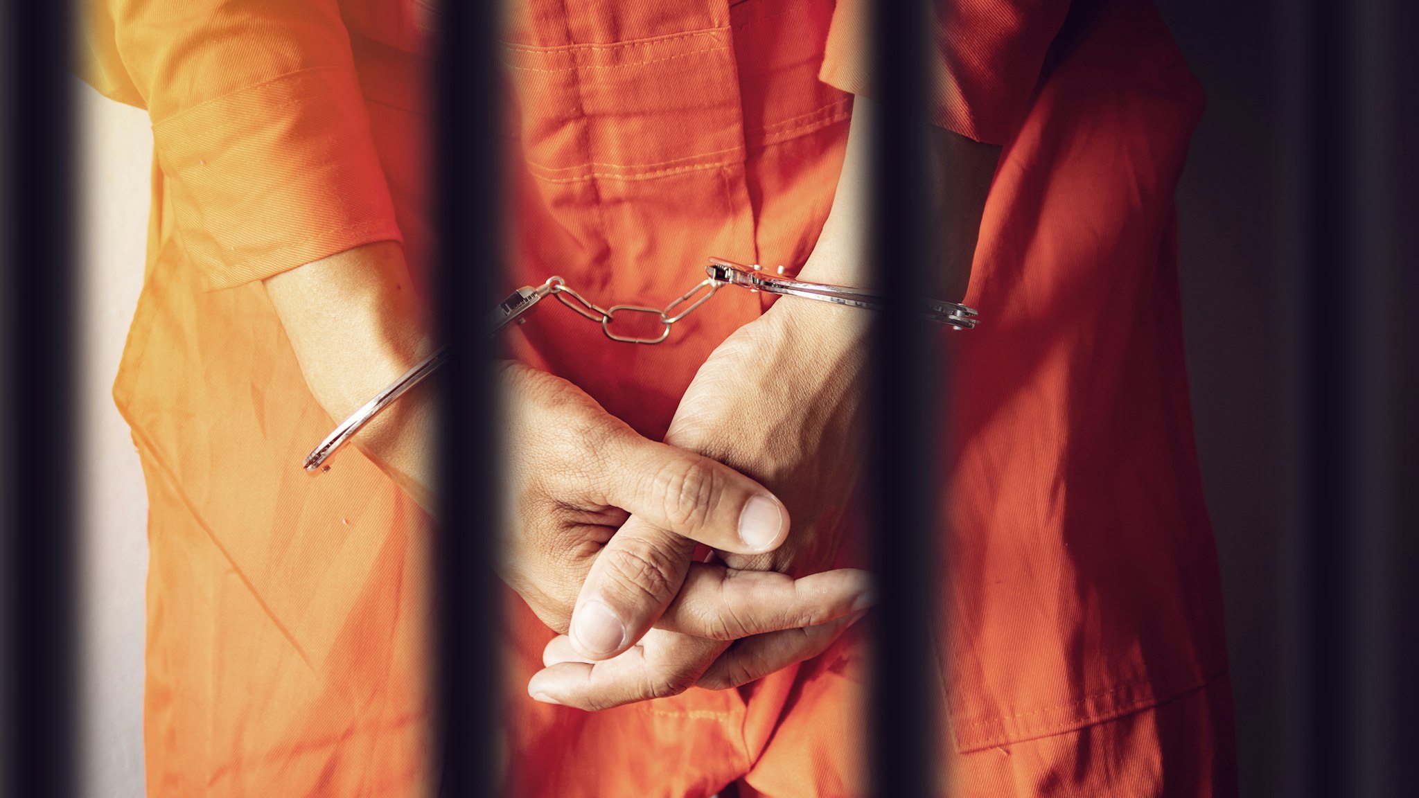 Midsection Of Prisoner With Handcuffs In Prison - stock photo