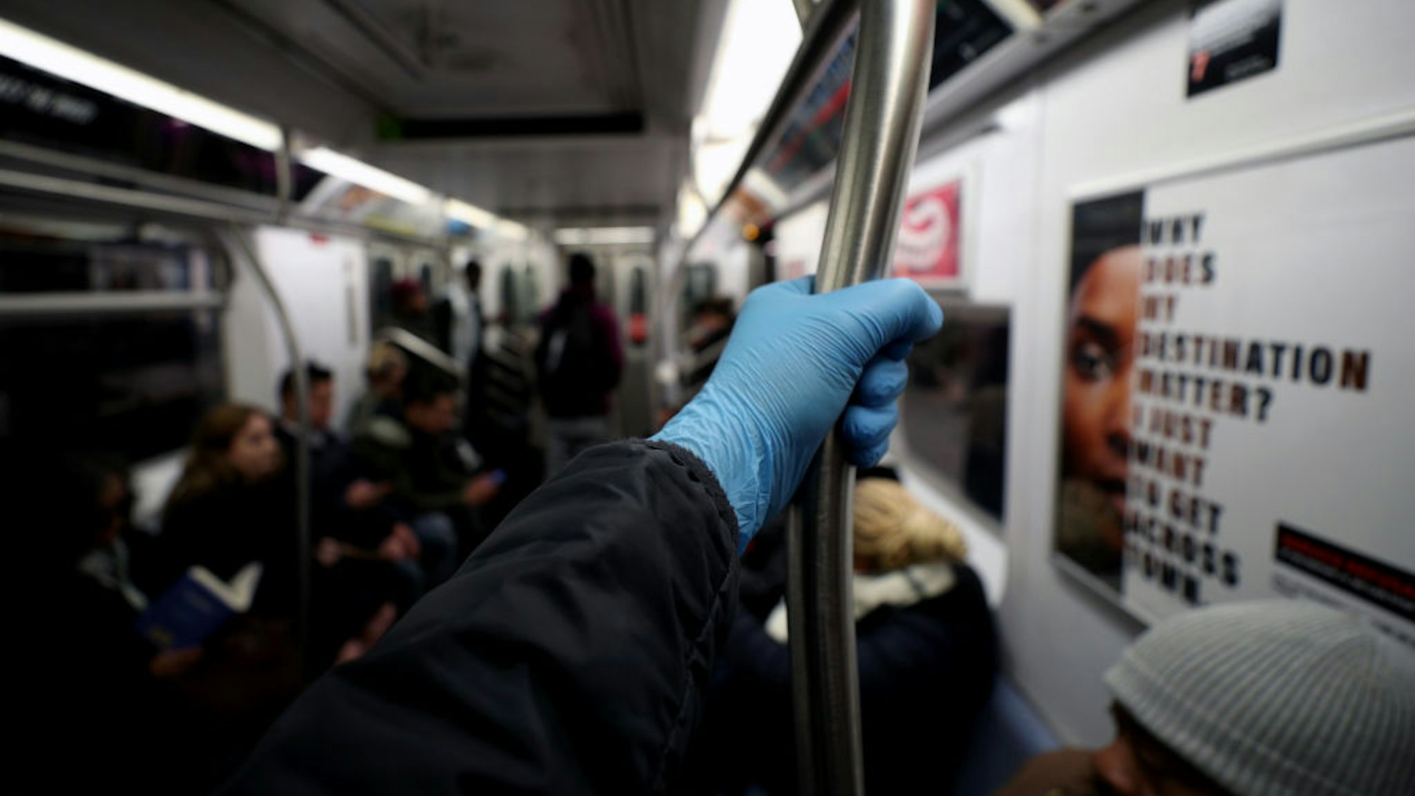 NEW YORK, USA - MARCH 11: A man wears surgical gloves to prevent Covid-19 spread, at the New York City subway train in New York, United States on March 11, 2020. (Photo by Tayfun Coskun/Anadolu Agency via Getty Images)NEW YORK, USA - MARCH 11: A man wears surgical gloves to prevent Covid-19 spread, at the New York City subway train in New York, United States on March 11, 2020. (Photo by Tayfun Coskun/Anadolu Agency via Getty Images)