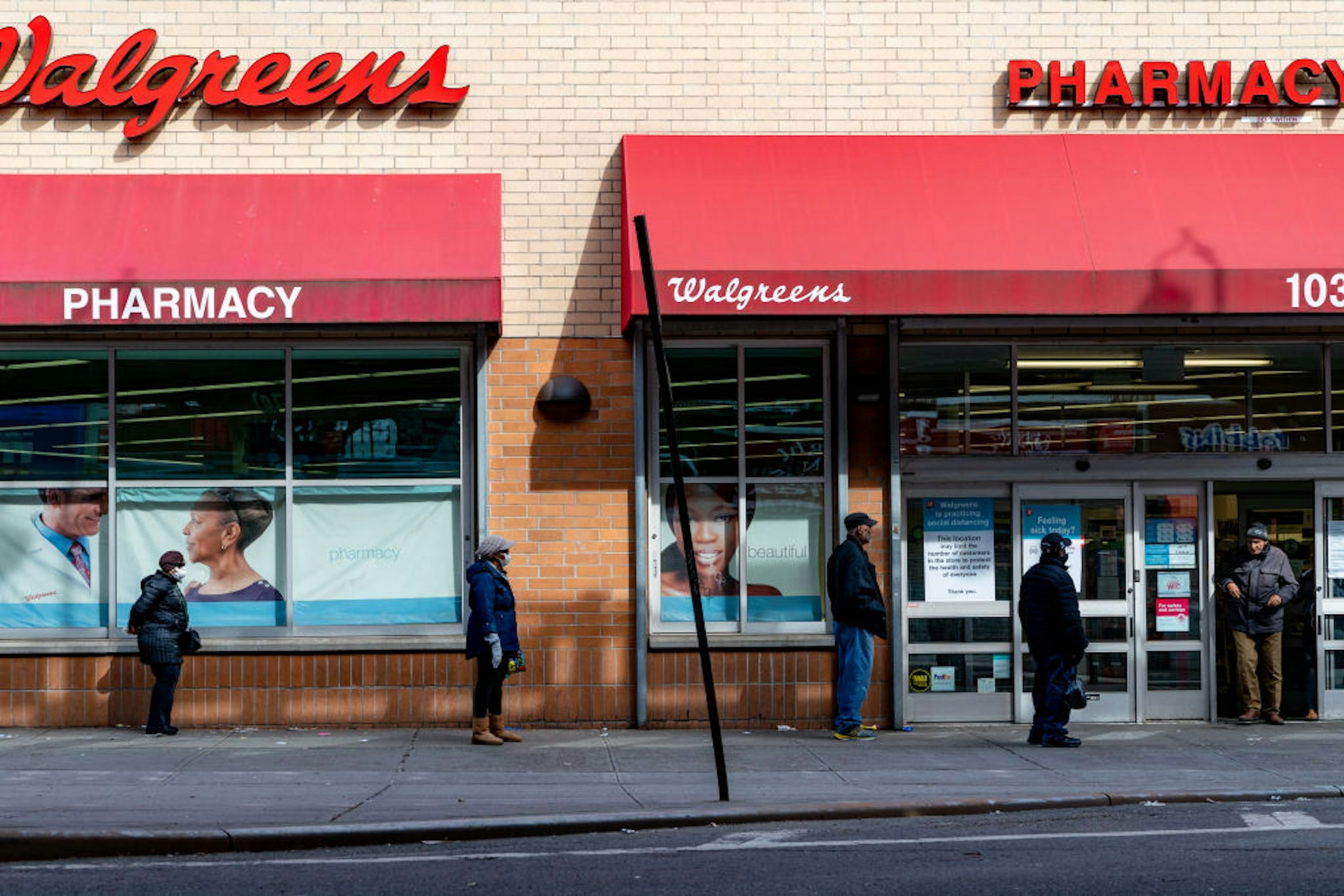 People stand in line outside of Walgreens on Westchester Avenue on April 14, 2020 in the Bronx borough of New York City.