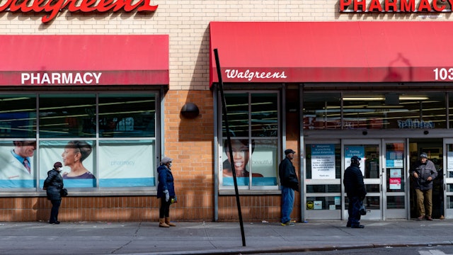 People stand in line outside of Walgreens on Westchester Avenue on April 14, 2020 in the Bronx borough of New York City.