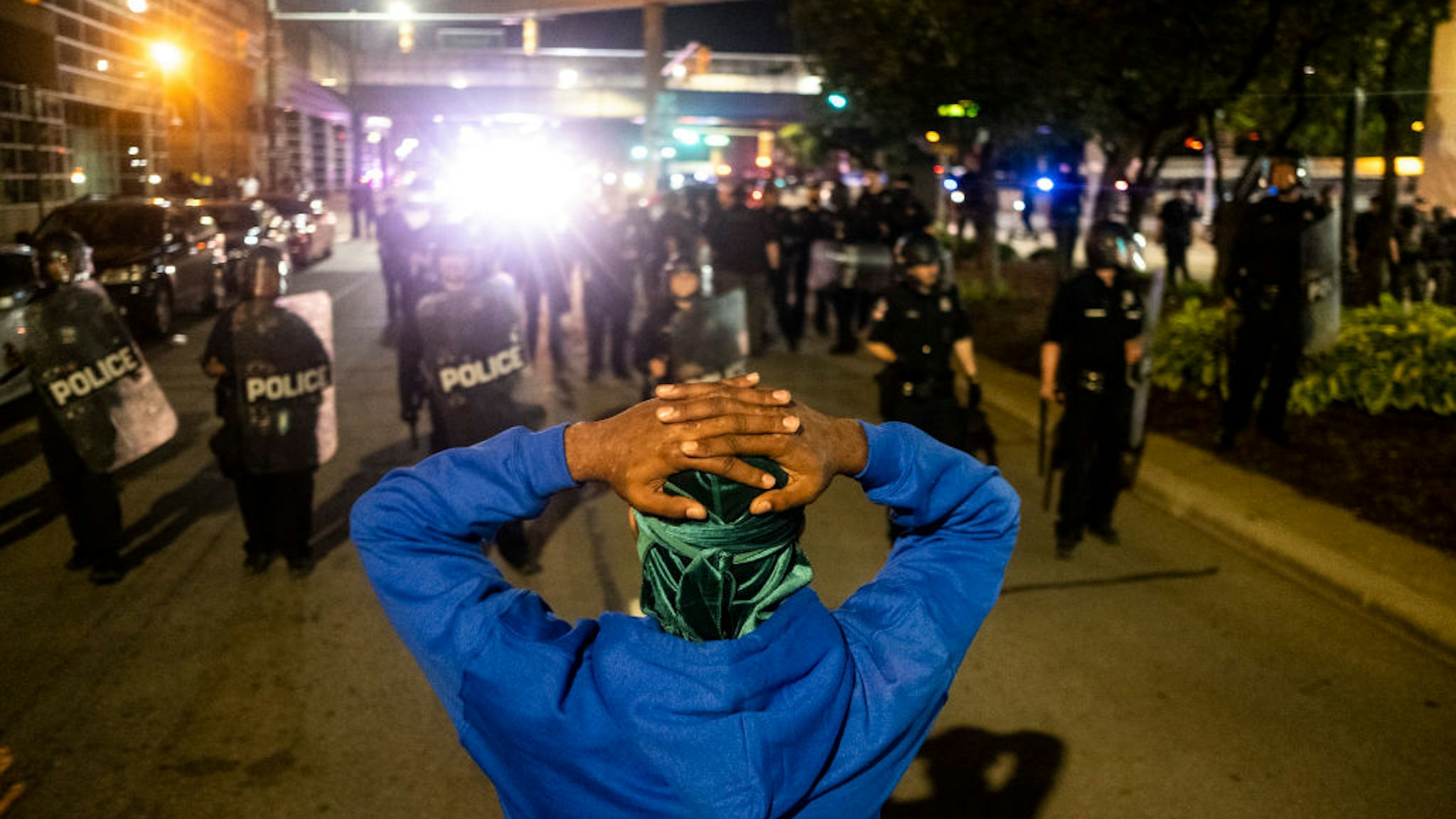 DETROIT, MI - MAY 29: Protester faces a line of police as over 1000 protesters gathered on May 29, 2020 in Detroit, Michigan. A solidarity rally was held with other nationwide protests against the death of Minneapolis, Minnesota resident, George Floyd. Protests continued later into the night police and protesters clashed in a series of violent confrontations where police arrested dozens and used tear gas and pepper spray. (Photo by Matthew Hatcher/Getty Images)