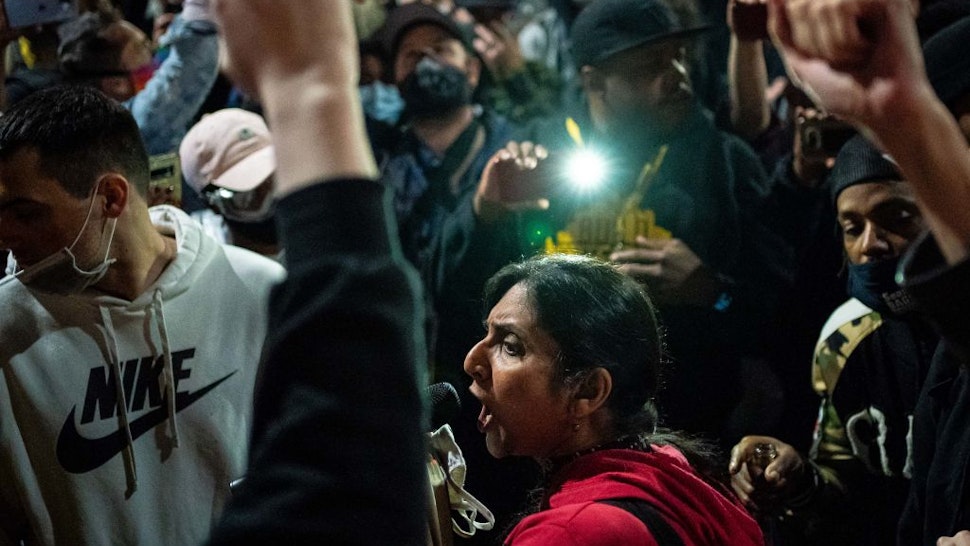 Seattle City Council member Kshama Sawant, a critic of Mayor Jenny Durkan and the Seattle Police Department, speaks as demonstrators hold a rally outside of the Seattle Police Departments East Precinct, which has been boarded up and protected by fencing, on June 8, 2020 in Seattle, Washington.