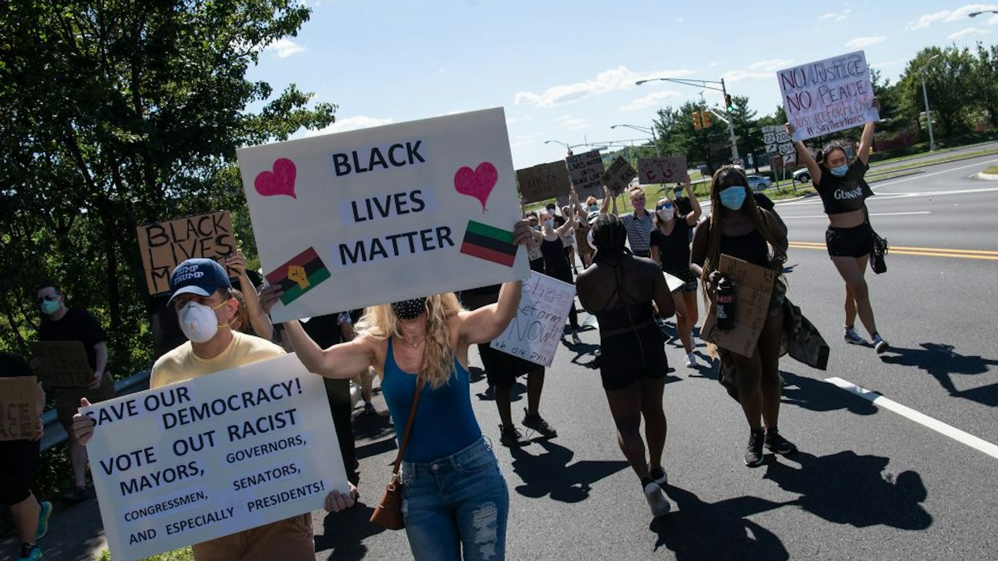 Protesters march in Bridgewater, New Jersey, on June 13, 2020 during a demonstration against police brutality and racism following the death of unarmed African-American George Floyd in Minneapolis on May 25.