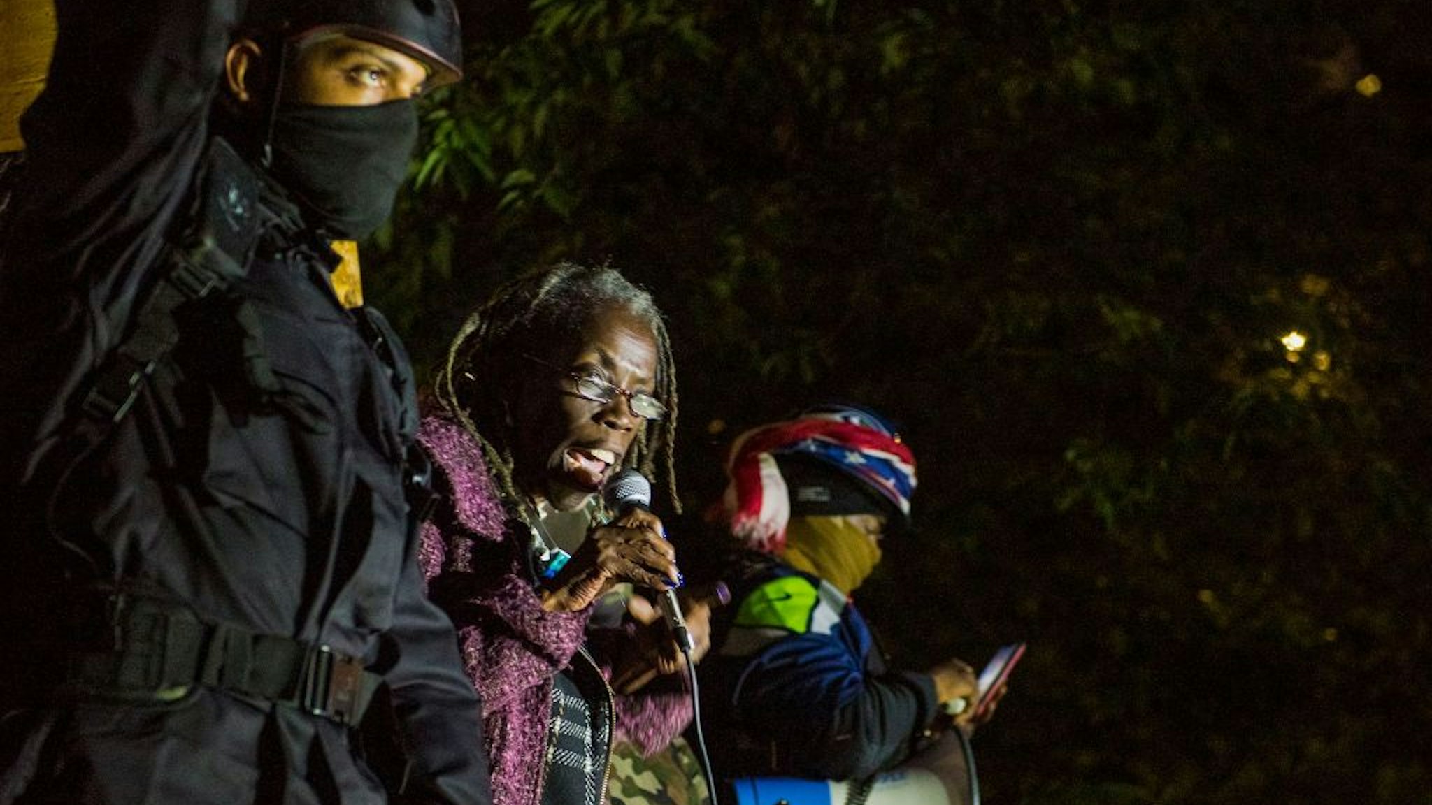 Portland City Commissioner Jo Ann Hardesty (C) addresses protesters as they take part in a rally against police brutality in Portland, Oregon late July 24, 2020