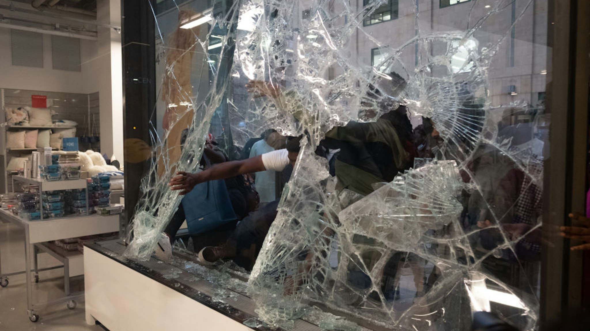 People break the glass of a Nordstrom store before stealing merchandise in downtown Minneapolis, US on August 26, 2020.