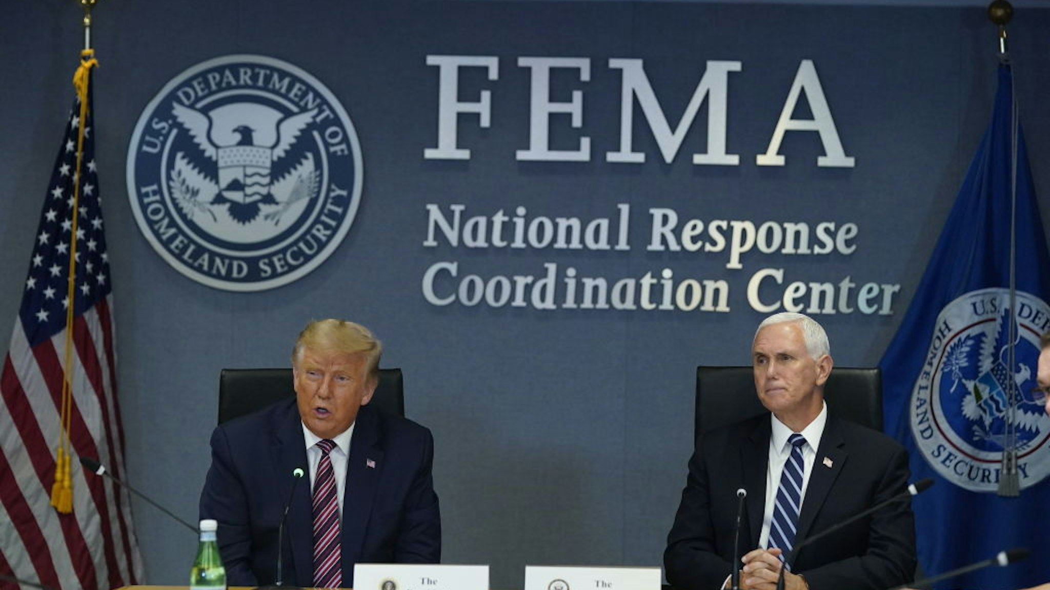 U.S. President Donald Trump speaks while Vice President Mike Pence, right, listens during a meeting at the Federal Emergency Management Agency (FEMA) headquarters in Washington, D.C., U.S., on Thursday, Aug. 27, 2020. Donald Trump visited FEMA to monitor Tropical Storm Laura's assault on the Gulf Coast -- hours before hes set to accept the GOP nomination for president.