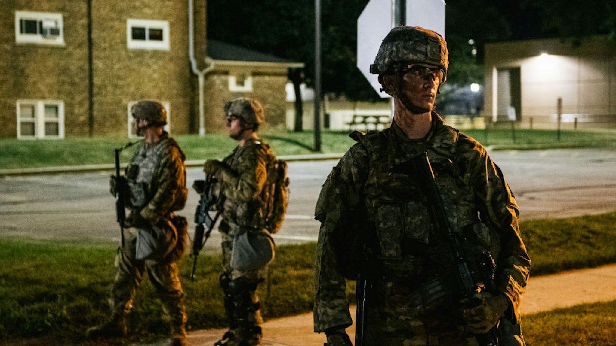 KENOSHA, WI - AUGUST 27: National Guard troops stand guard inside of a fenced area that surrounds several government buildings on August 27, 2020 in Kenosha, Wisconsin. Wisconsin Gov. Tony Evers approved a request for an additional 500 National Guard troops to be deployed into Wisconsin on August 26. Many arrests have been made with the additional presence of law enforcement. Civil unrest has occurred in multiple states after the shooting of Jacob Blake, 29, on August 23. Blake was shot multiple times in the back by Wisconsin police officers after attempting to enter into the drivers side of a vehicle. (Photo by Brandon Bell/Getty Images)