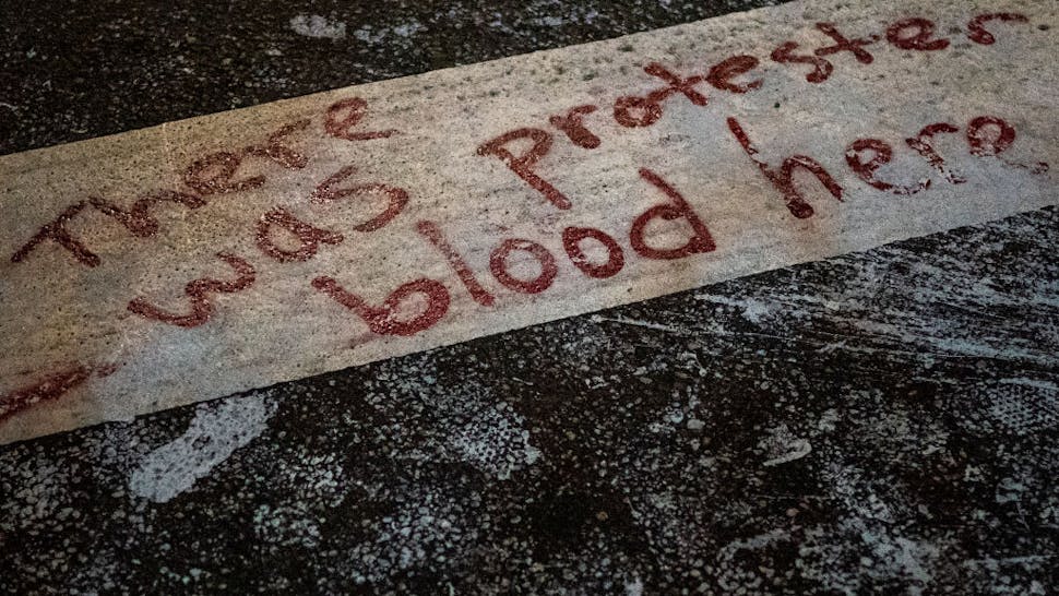 Portland PORTLAND, OR - SEPTEMBER 5: The words There was protester blood here are seen here in a crosswalk after Portland police injured a woman during an arrest early in the morning on September 5, 2020 in Portland, Oregon. Friday night marked the 99th night of protests in Portland following the death of George Floyd in police custody. (Photo by Nathan Howard/Getty Images)