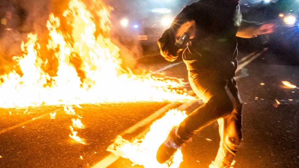 Daily Protests In Portland Continue Into Third Month A protester, whos feet caught fire after a molotov cocktail exploded on him, runs toward a medic during a protest against police brutality and racial injustice on September 5, 2020 in Portland, Oregon. Portland has seen
