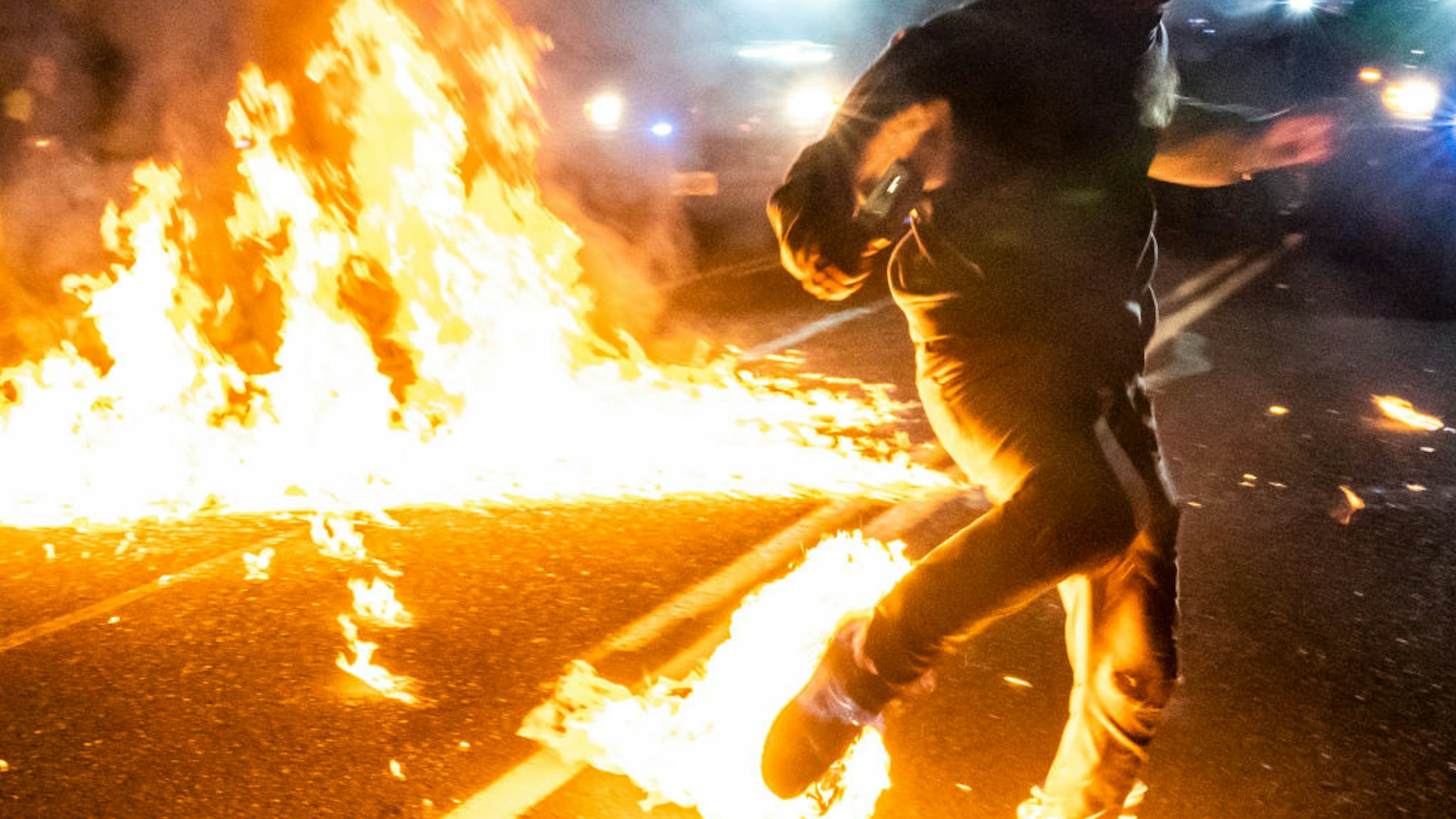 A protester, whos feet caught fire after a molotov cocktail exploded on him, runs toward a medic during a protest against police brutality and racial injustice on September 5, 2020 in Portland, Oregon. Portland has seen