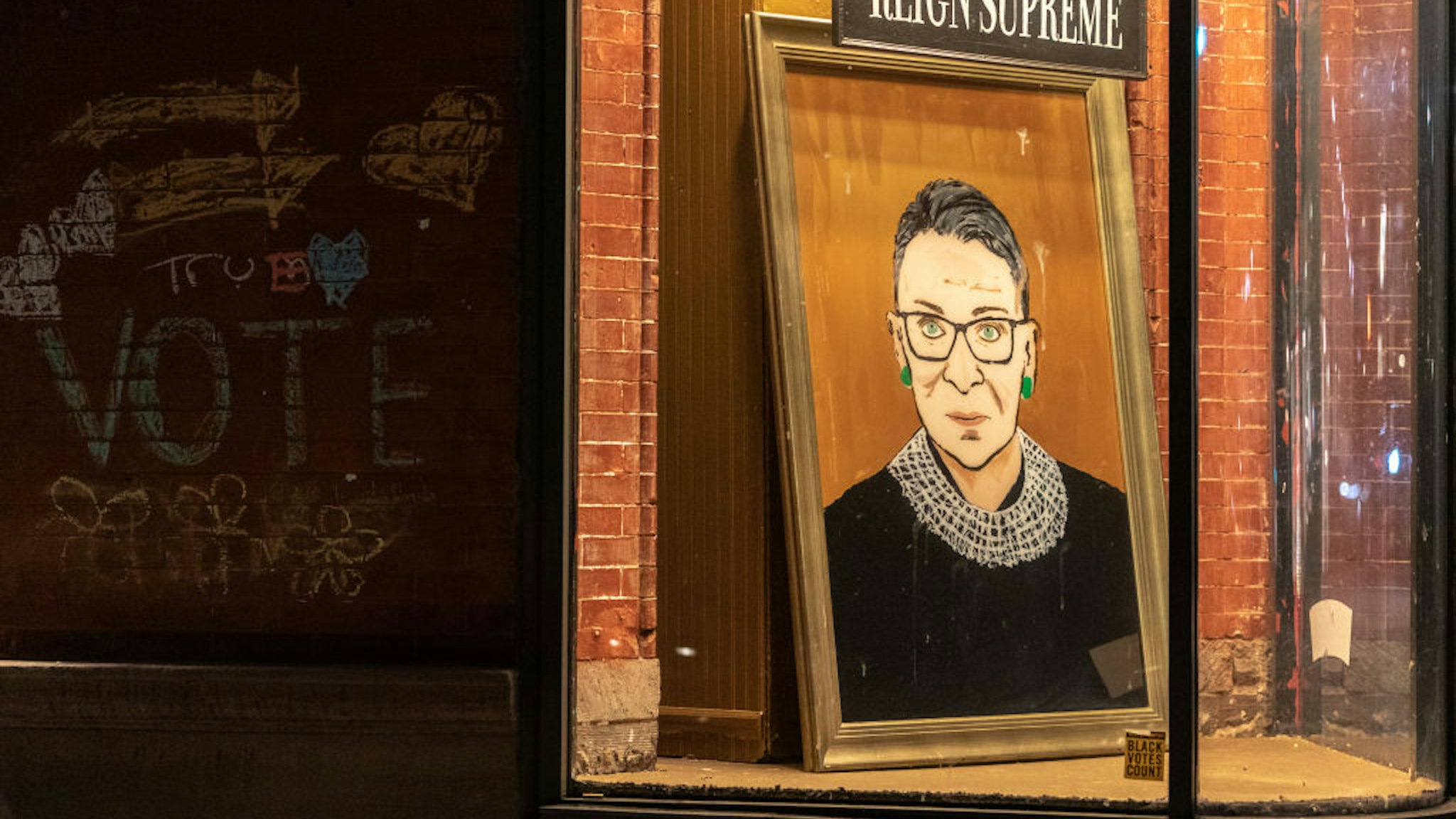 NEW YORK, NY - SEPTEMBER 19: A portrait of Supreme Court Justice Ruth Bader Ginsburg is displayed at a storefront on September 19, 2020 in New York, New York. Ginsburg has died at age 87 after a battle with pancreatic cancer. (Photo by Jeenah Moon/Getty Images)