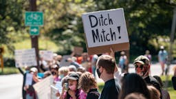 mcconnell protesters LOUISVILLE, KY - SEPTEMBER 19: A group of protesters rally in front of Senate Majority Leader Sen. Mitch McConnell's (R-KY) home on September 19, 2020 in Louisville, Kentucky. McConnell has said that if President Donald Trump nominates someone to take the place of Ginsburg following her death, the Senate would proceed with the nomination process despite the presidential election being less than six weeks away. (Photo by Jon Cherry/Getty Images)